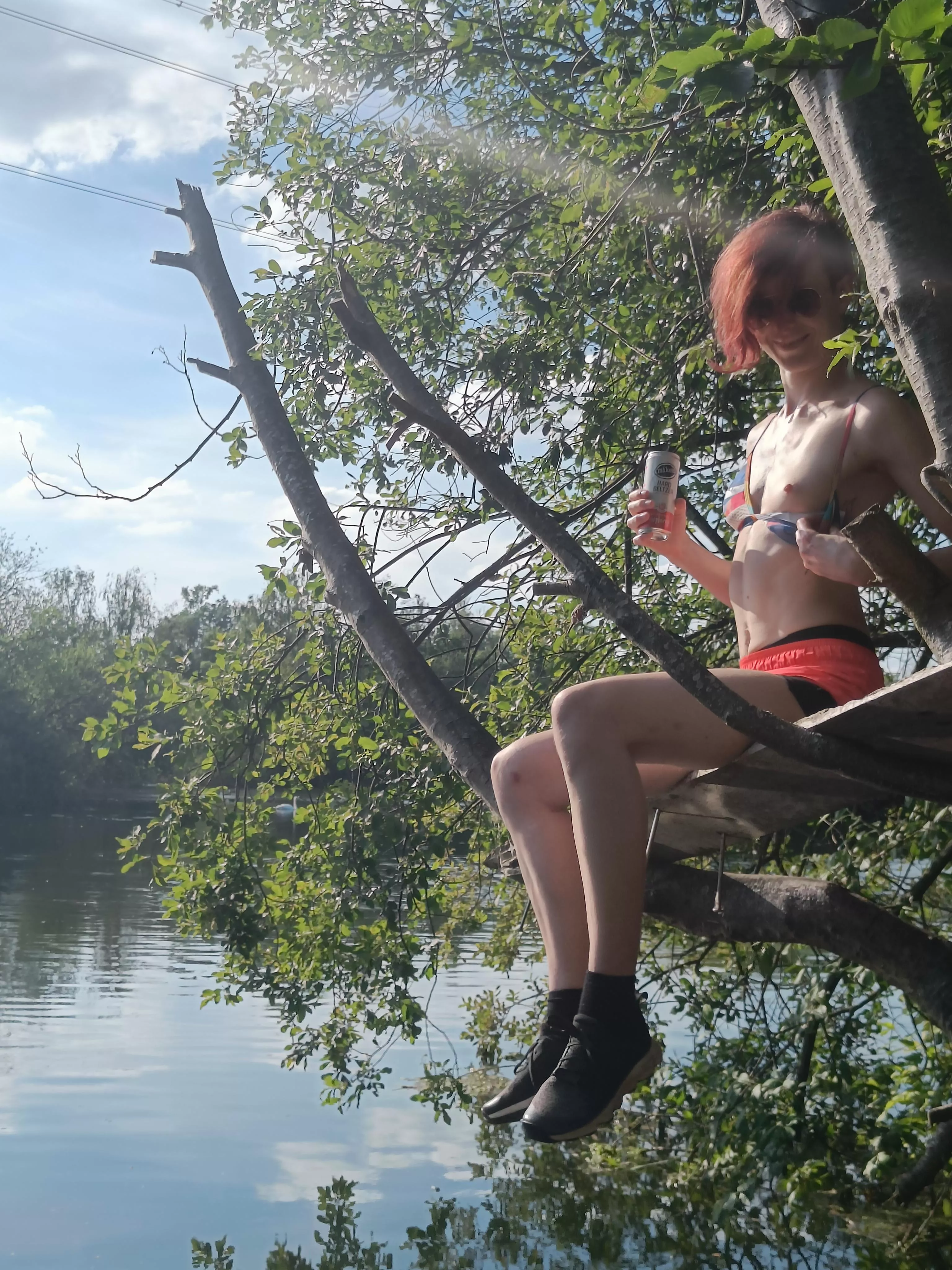 Flashing a tiny titty in a tree in the sun