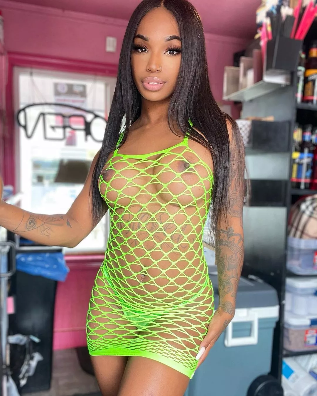 @blackbarbiiebarista wearing lime green fishnets