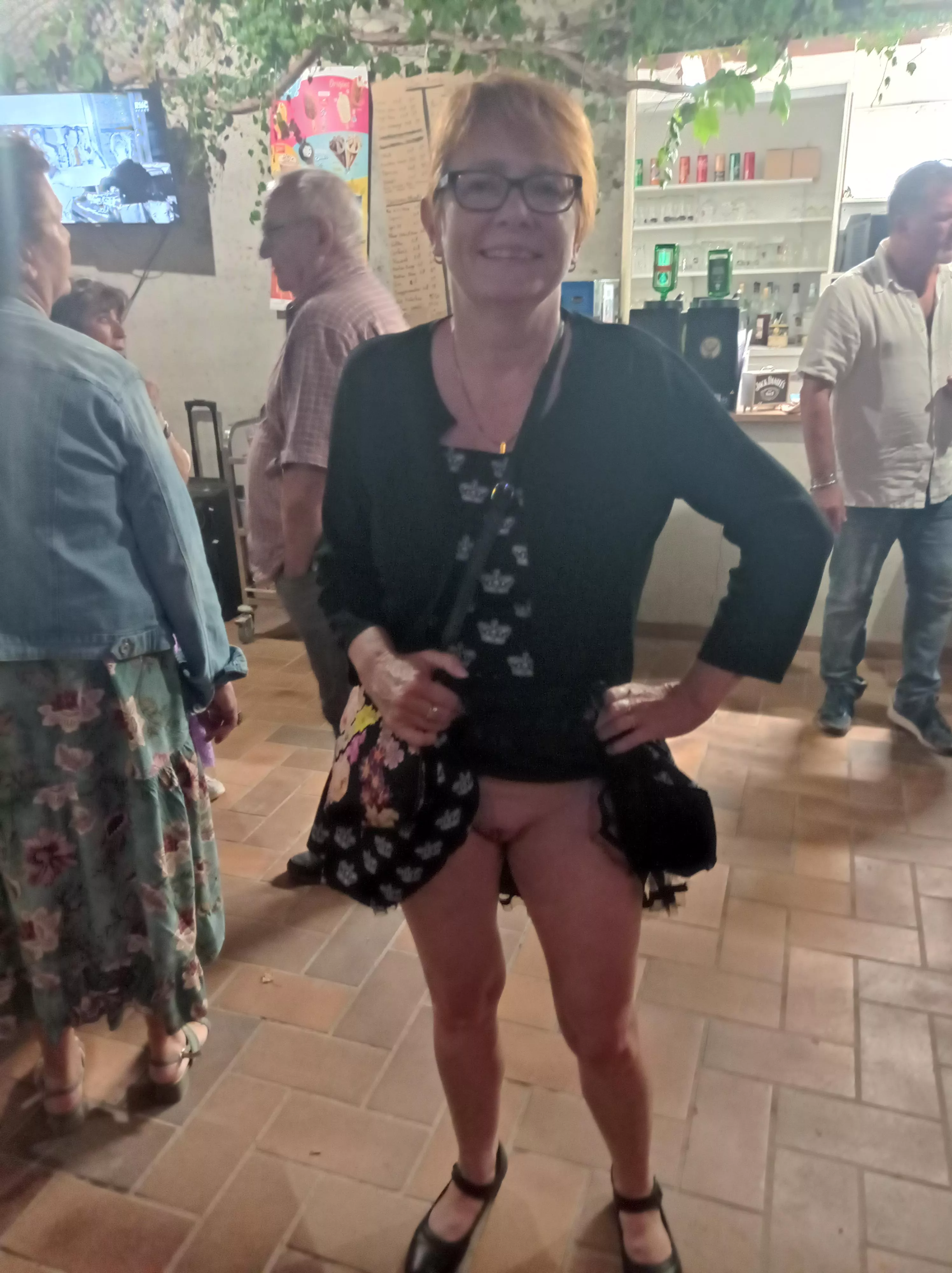 the redhead glasses BDSM MILF with shaved pussy and big tits flashing on public fiesta