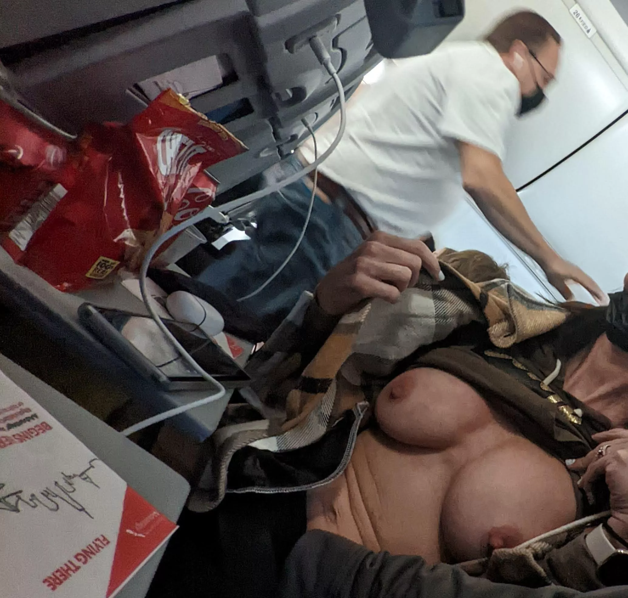 [IMG] Long flight, tits out. . . .