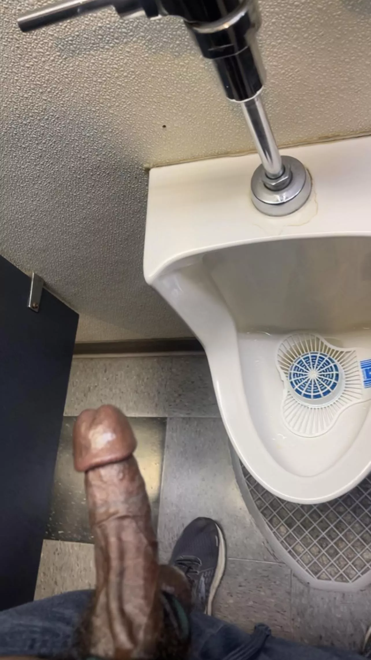 Stroking at the urinal