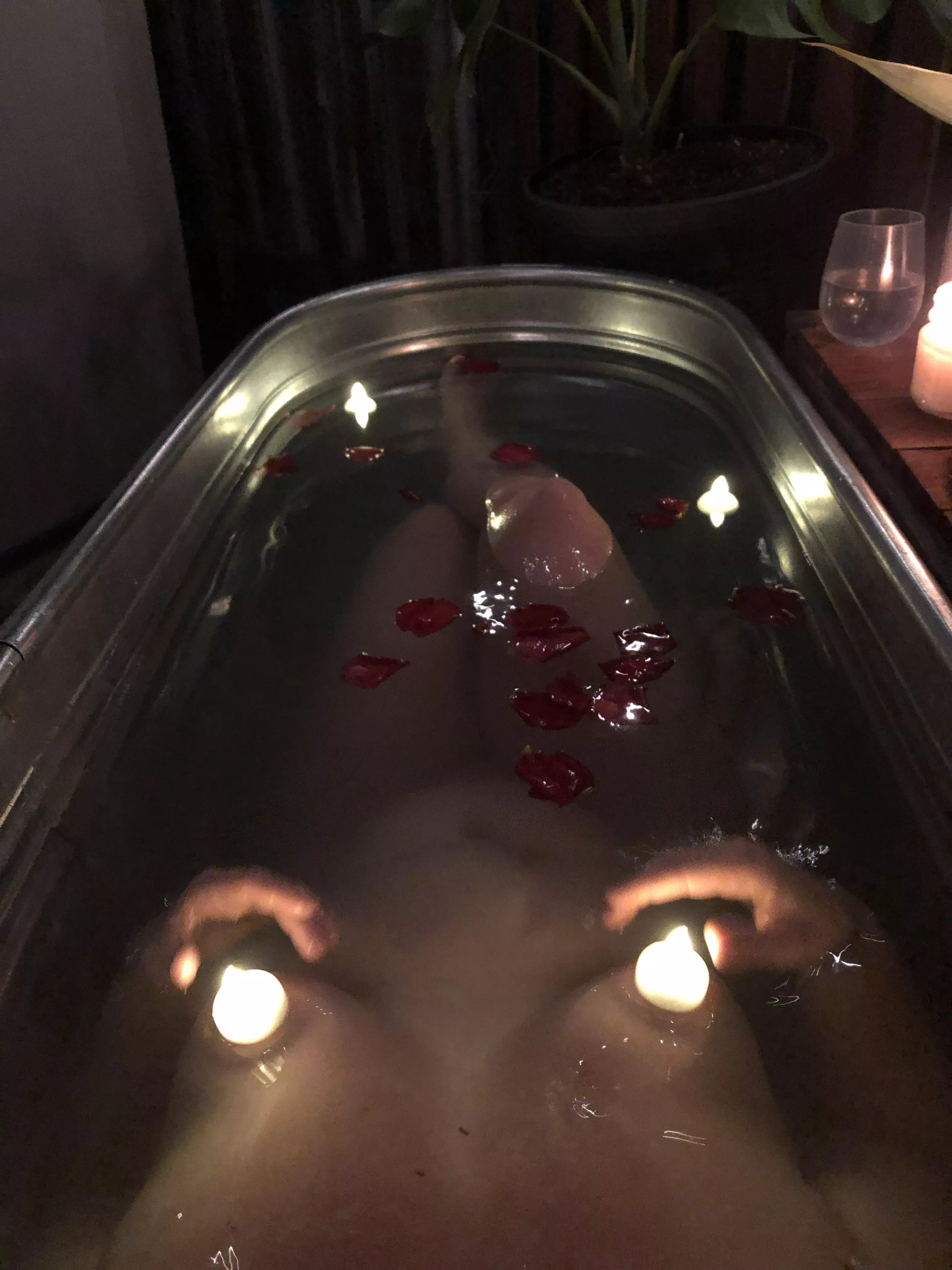 Our outdoor tub with rose petals and glowing candles