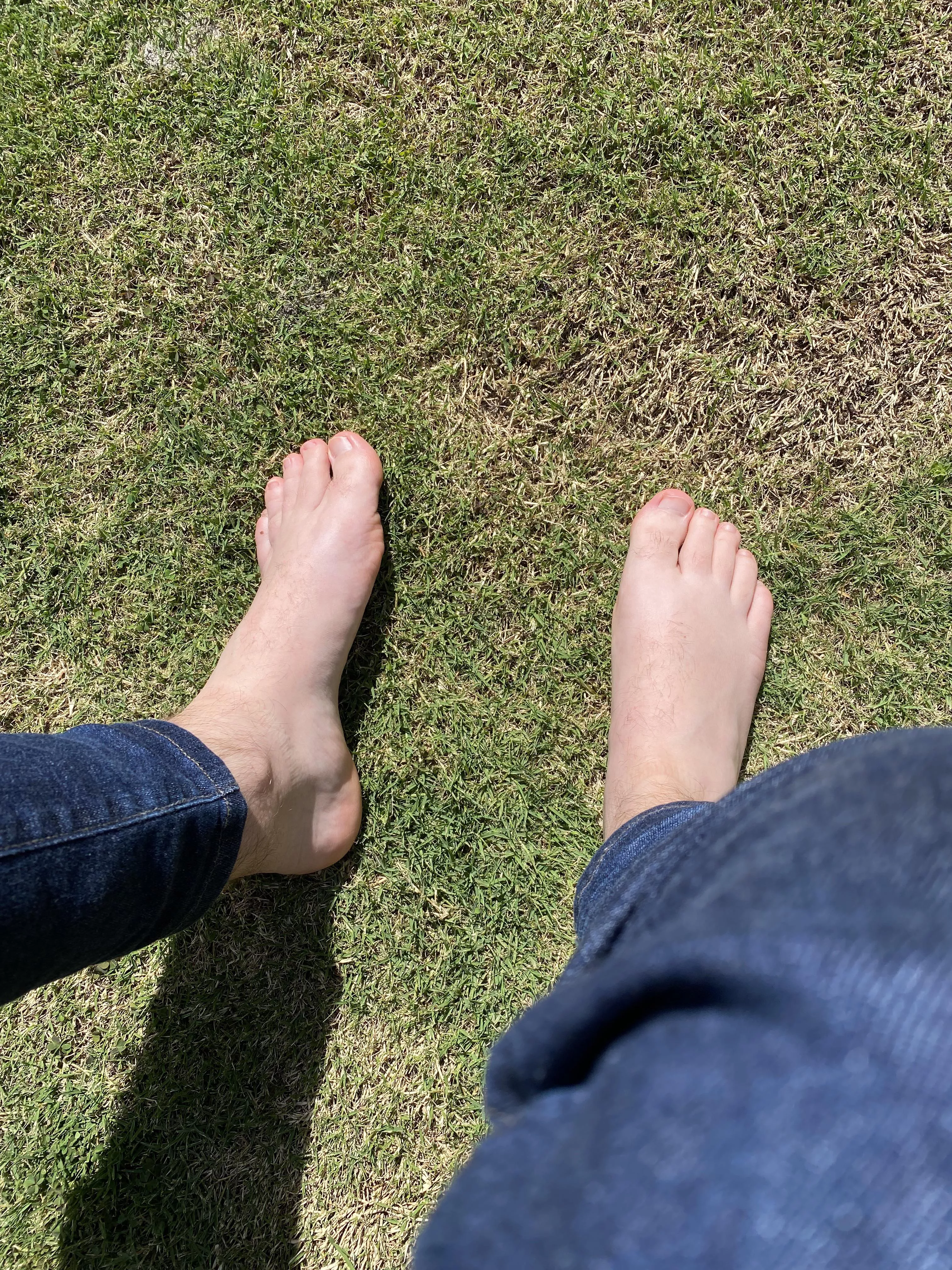 Green grass and pale feet