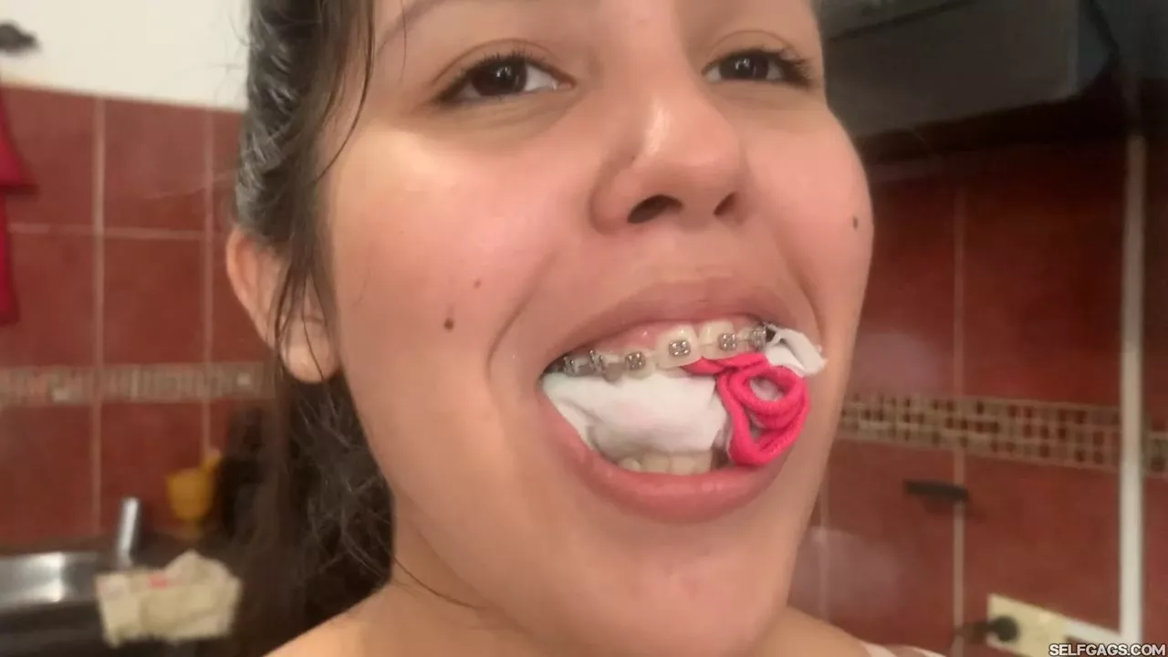 Smiling wiht panties in her mouth (they were dirty by the way)