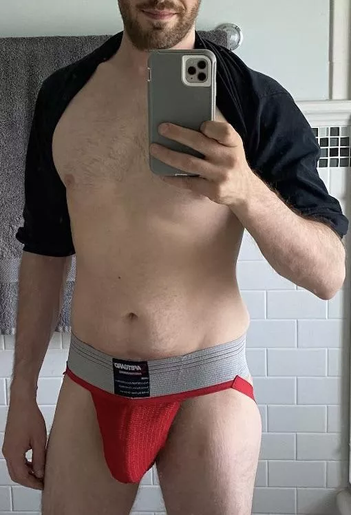 Bulging in classic red jockstrap…