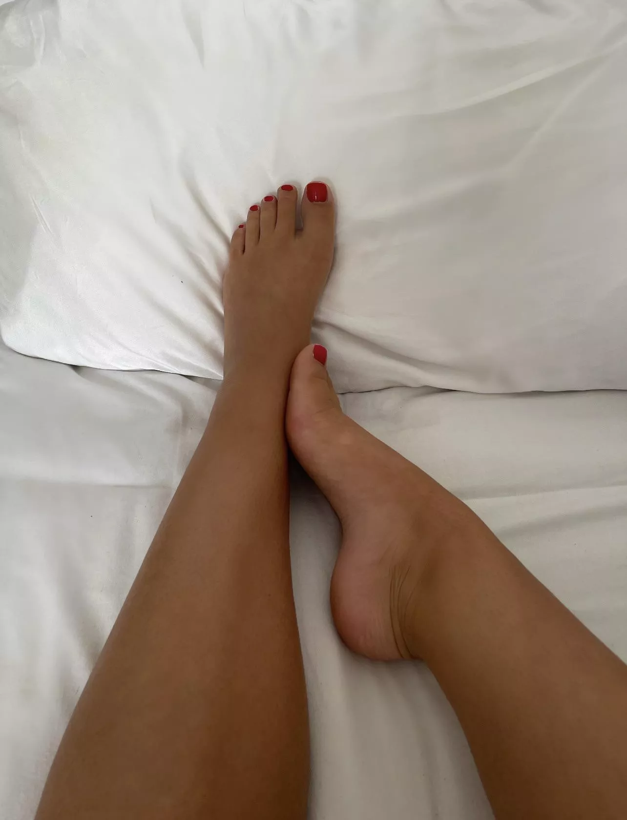 Red toenails on tanned skin