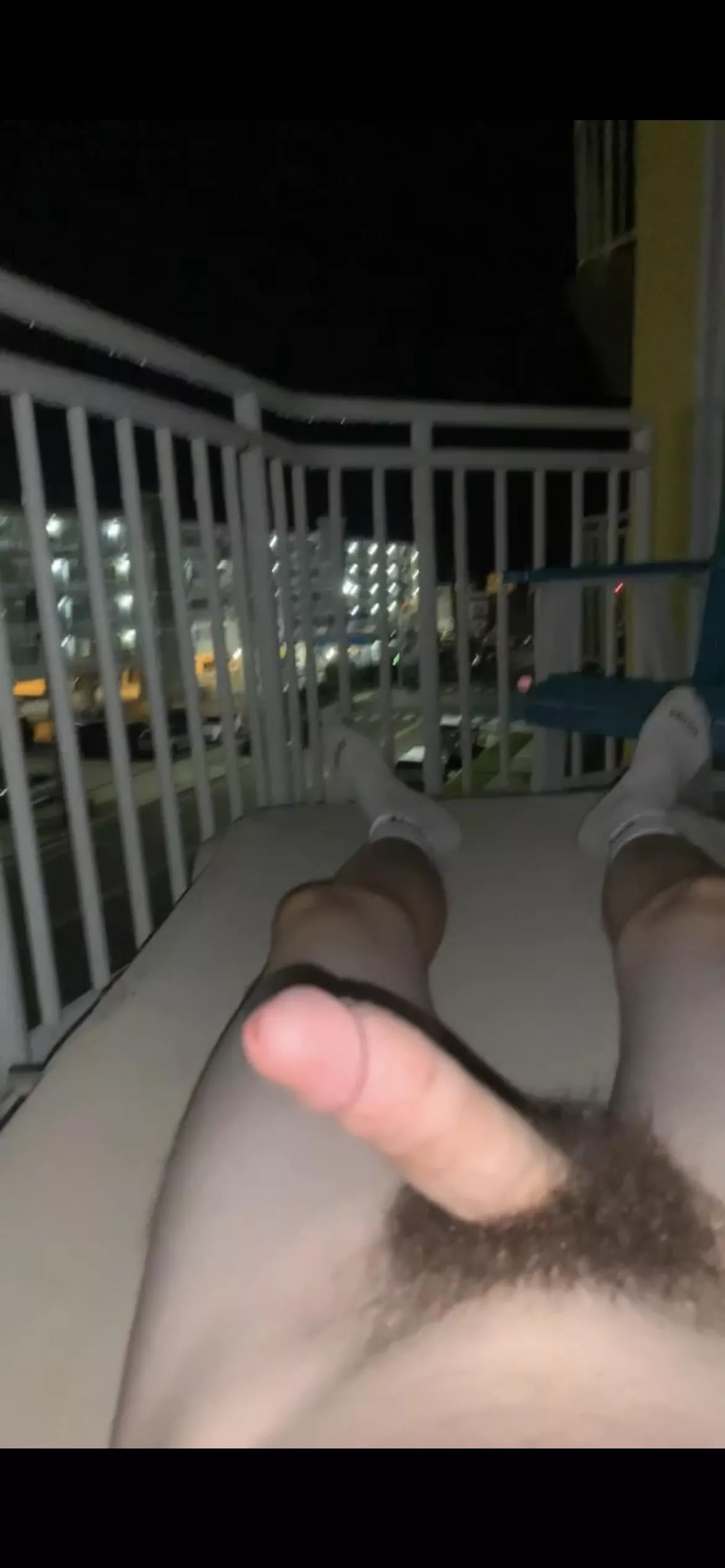 Laying naked on the balcony