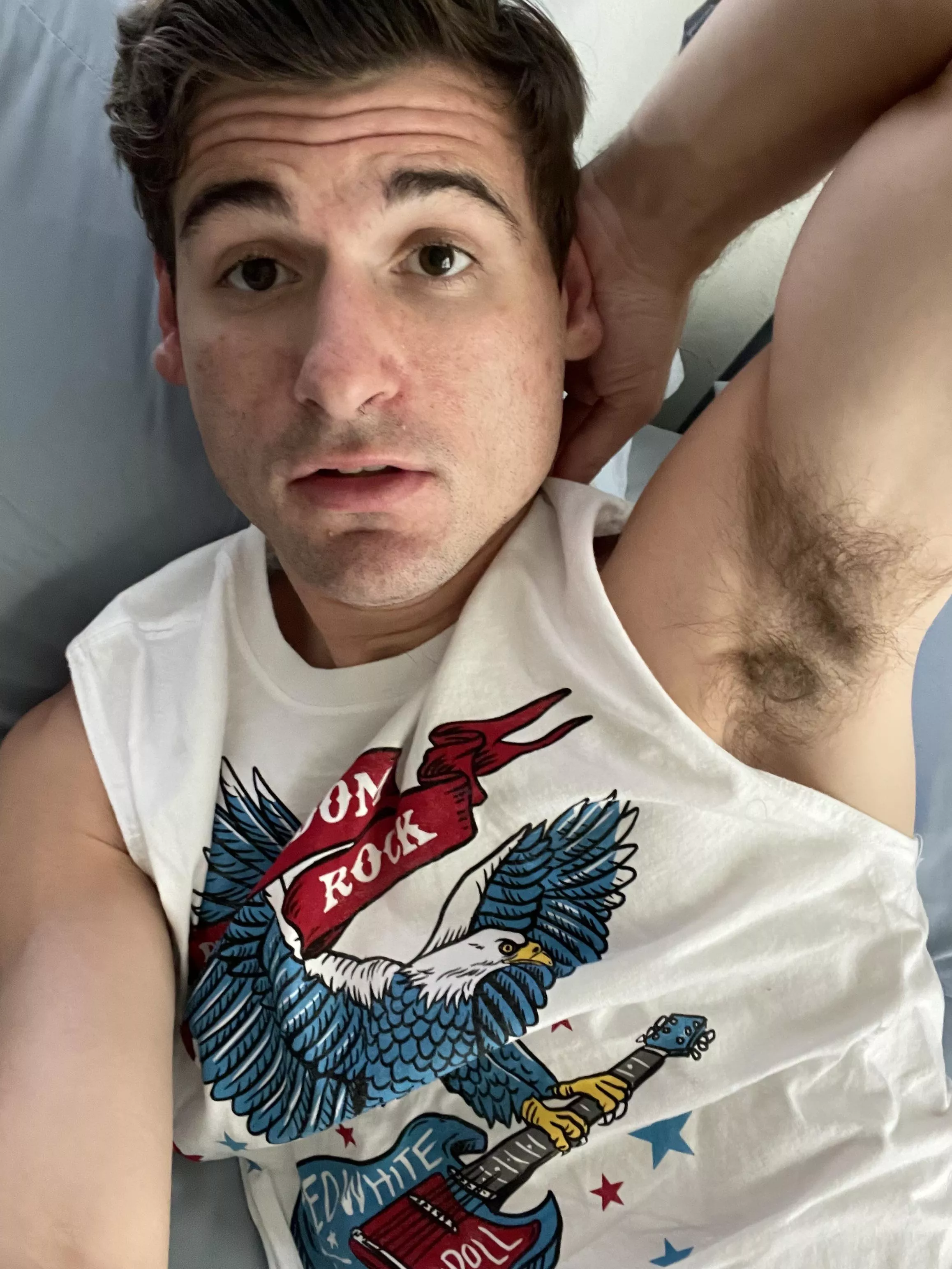 Ditzy guy showing armpit