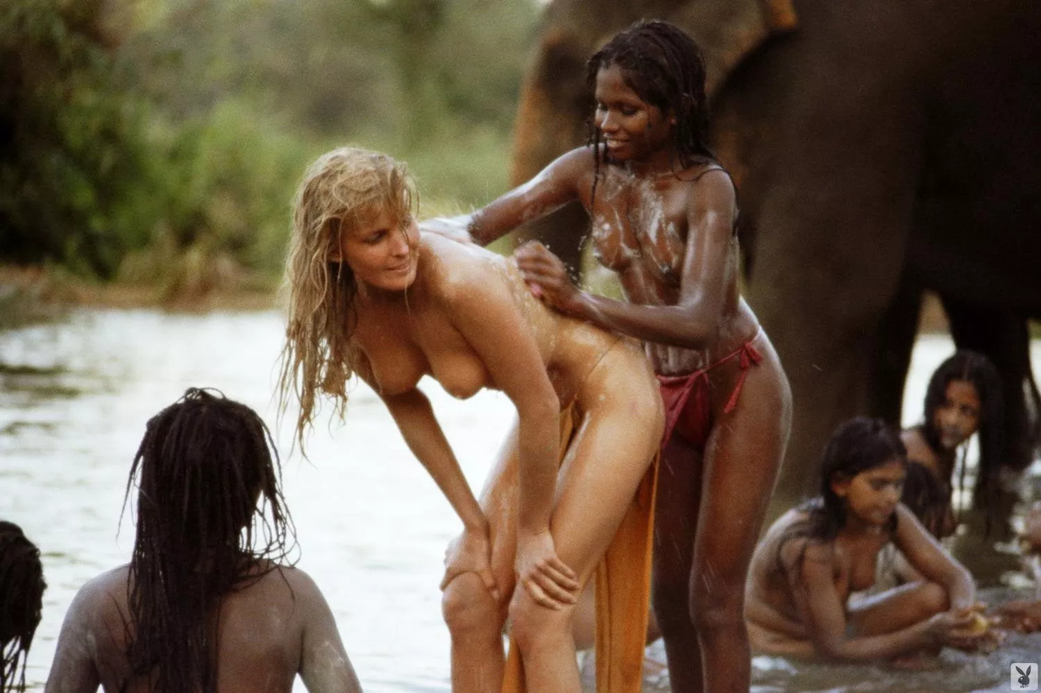 Bo Derek -- BTS of Tarzan the Ape Man (1981) Being washed down by a native after the famous white paint scene.