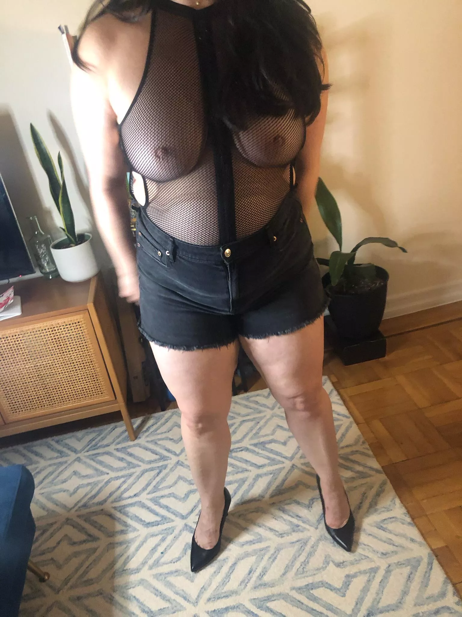 Bursting out of my fishnet bodysuit.