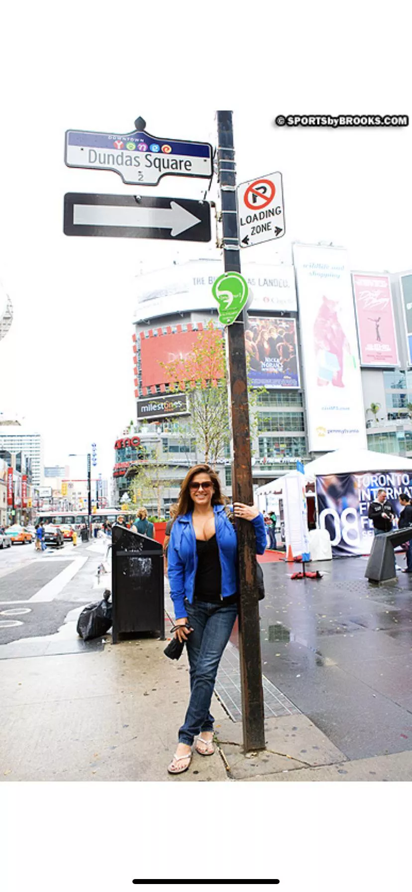 Busty against a (street) pole