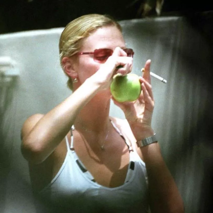 Charlize Theron smoking a cigaretteâ€¦and an apple ðŸ˜‰