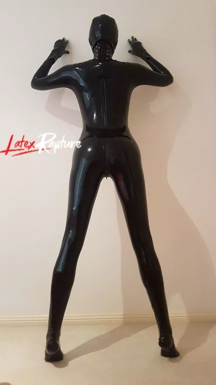 Completely covered in latex with added neck corset. Against the wall the way I like it 💋