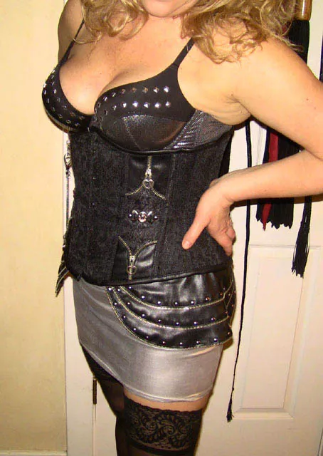 Dressing for success ! Leather corset and a short silver mini :)