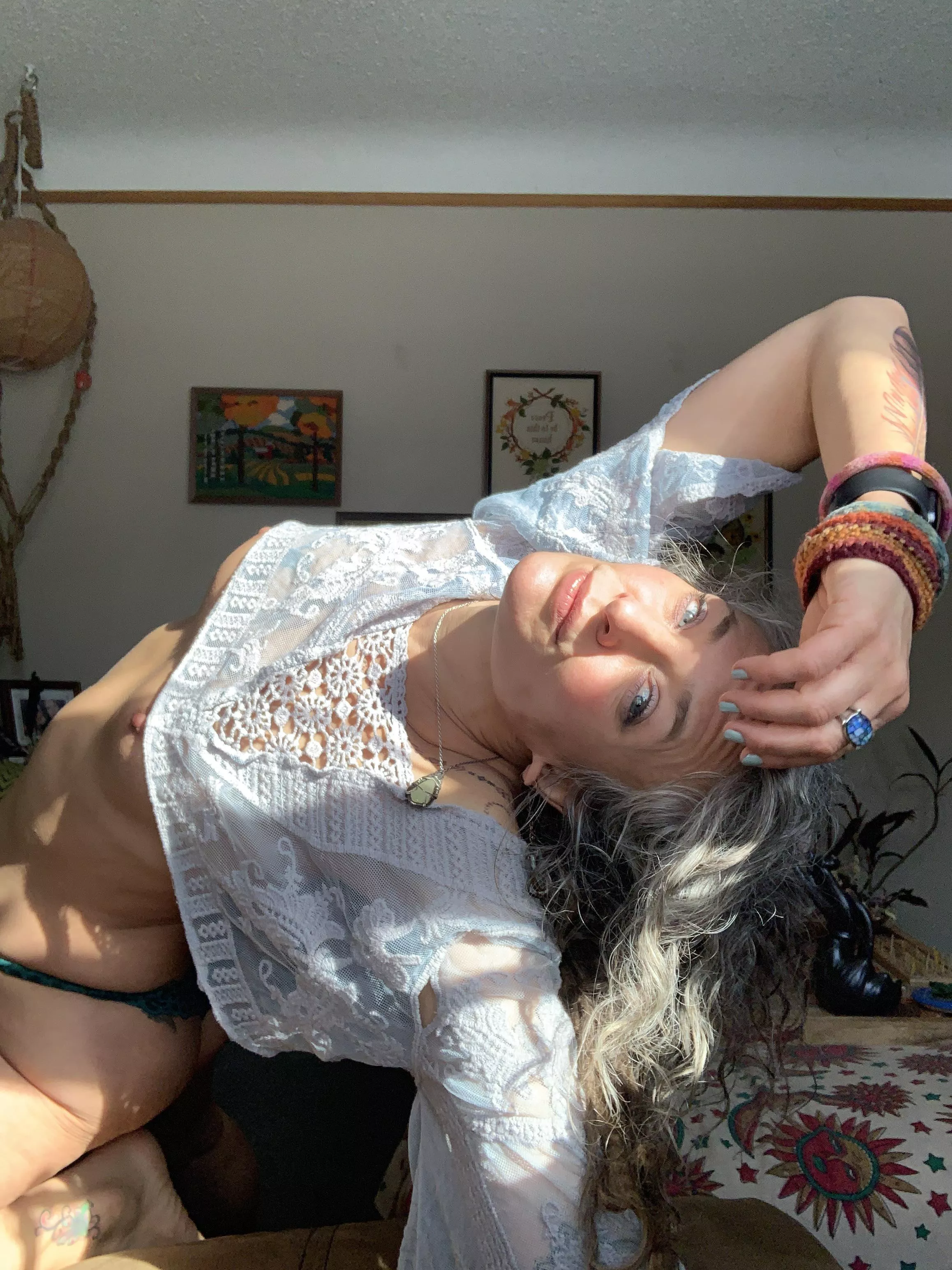 Heart opener stretch with my hard nips just peeking out from my cropped bohemian lace top, light rays too