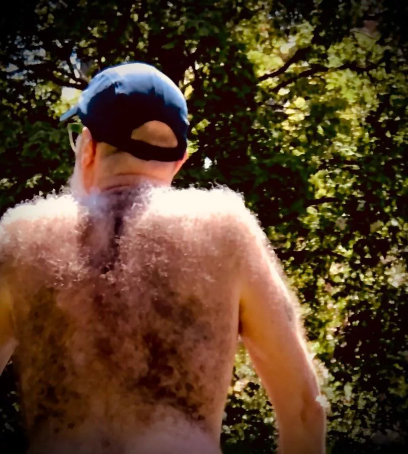 Insanely hairy back on shirtless dad in the park