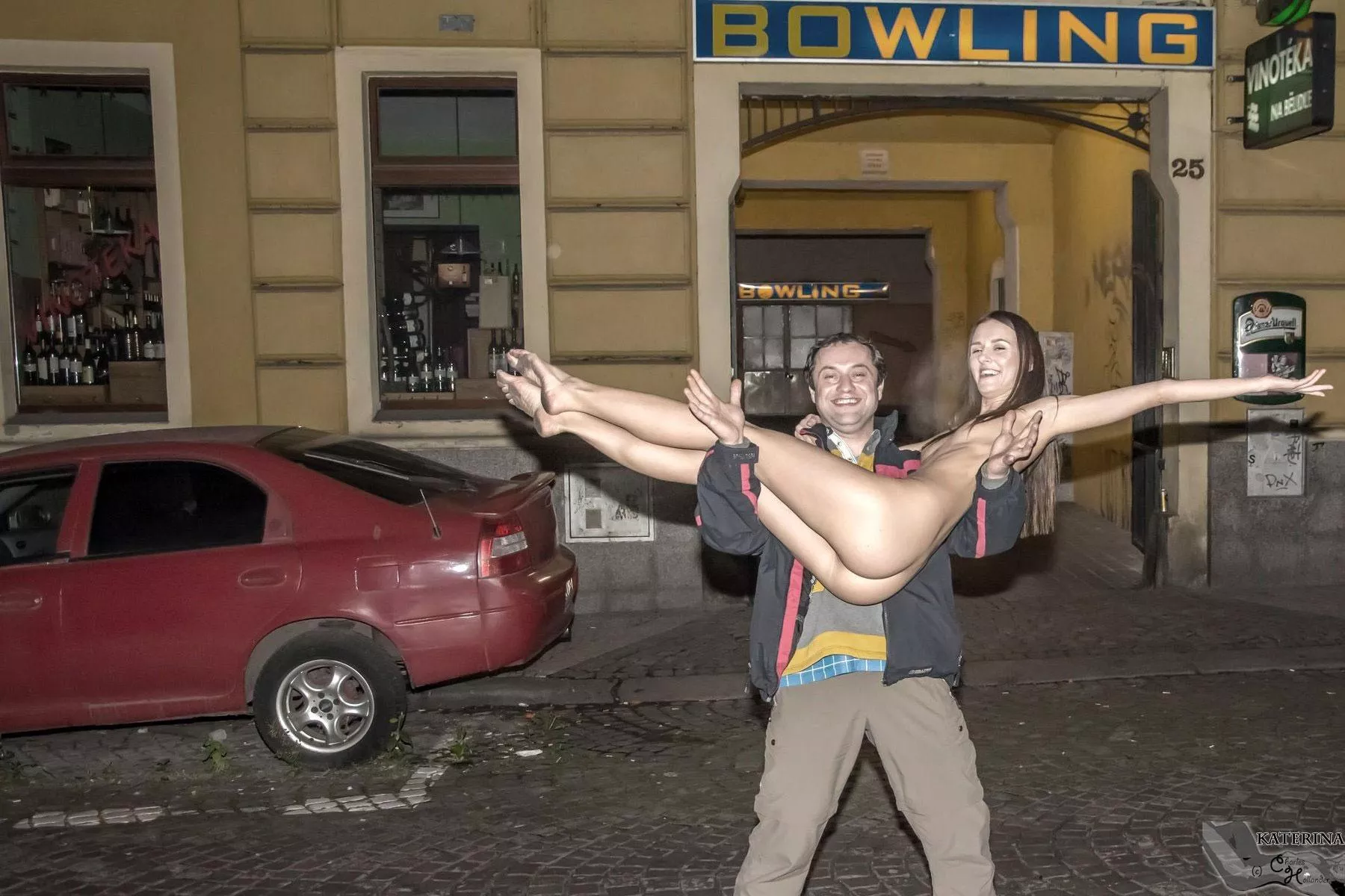 Katerina exposed in front of public bowling center. Nude.