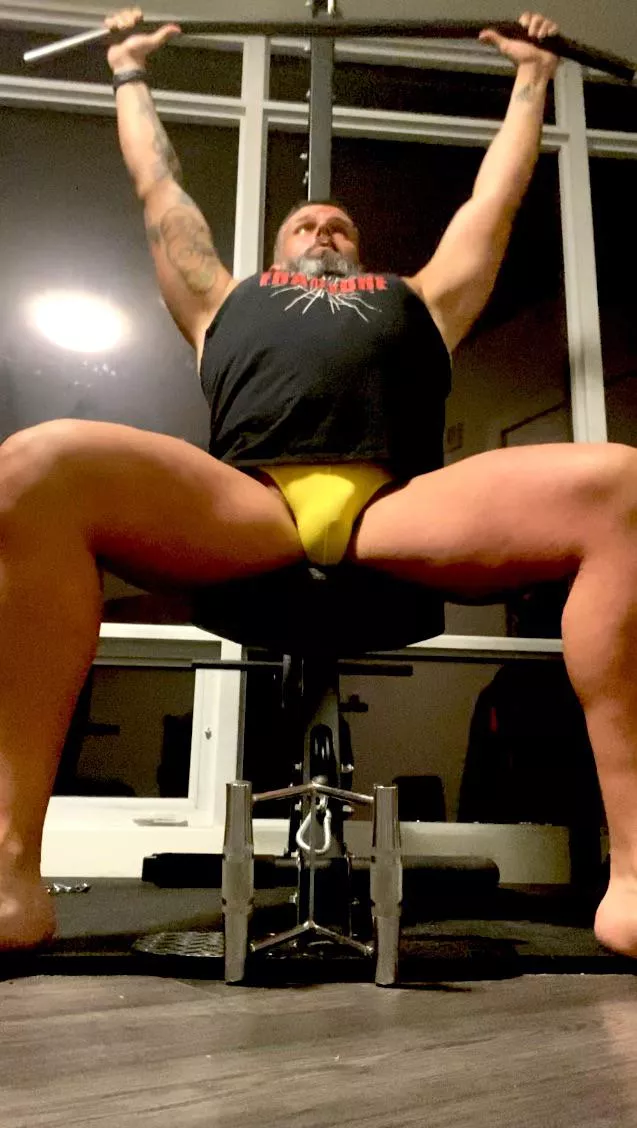 Lat pulldowns in a thong.