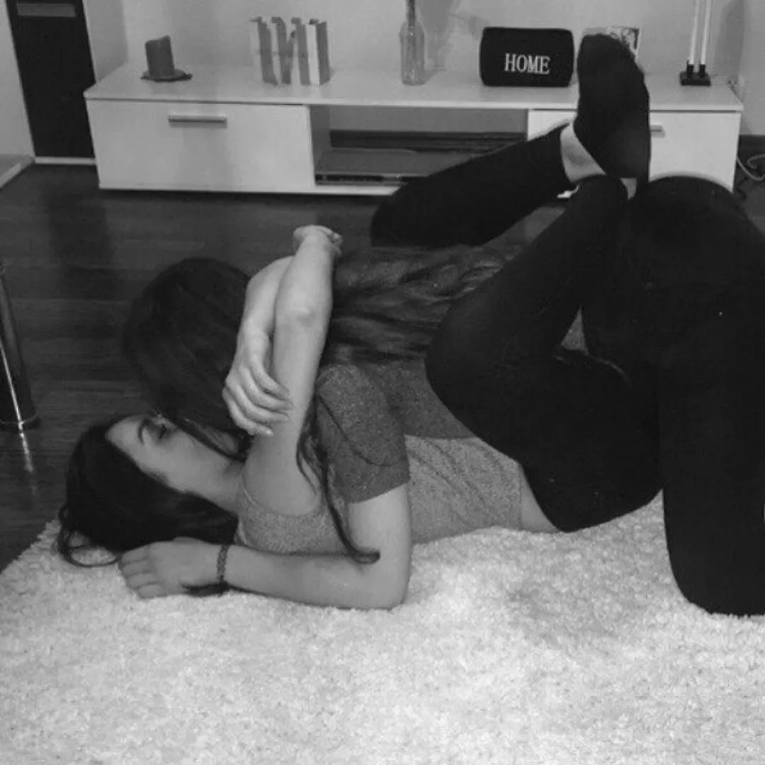 lesbian couple kissing on the floor