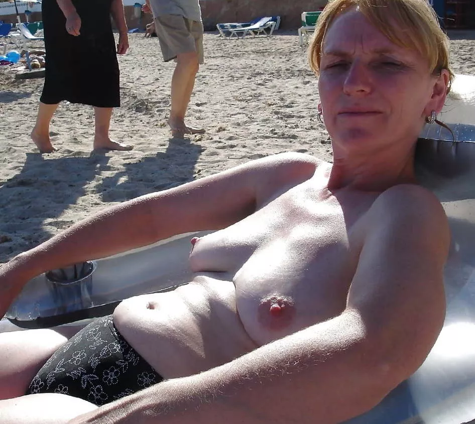 Mom is always alluring at the beach with that belly and those succulent sagging tits