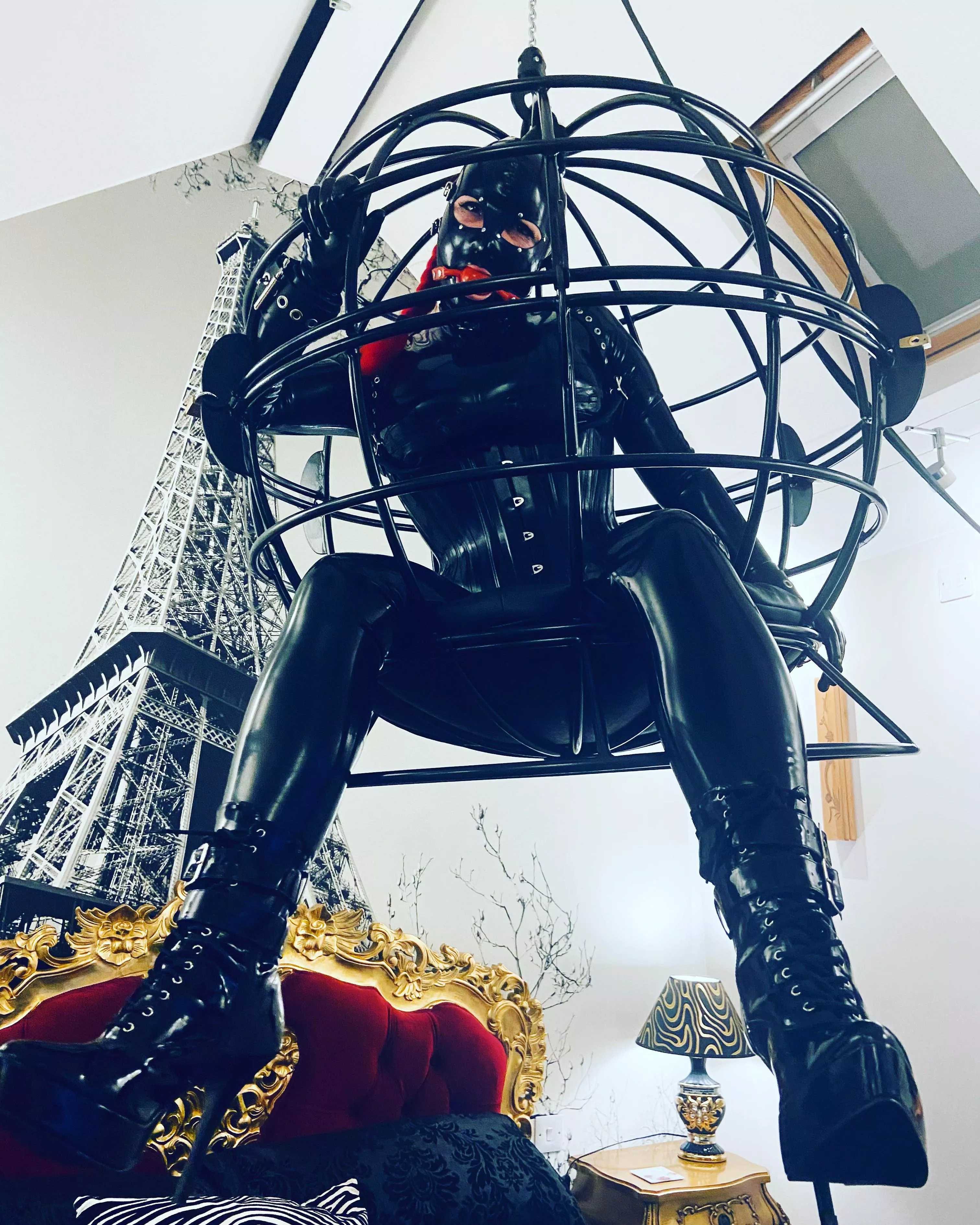 My shiny rubberdoll in her cage.