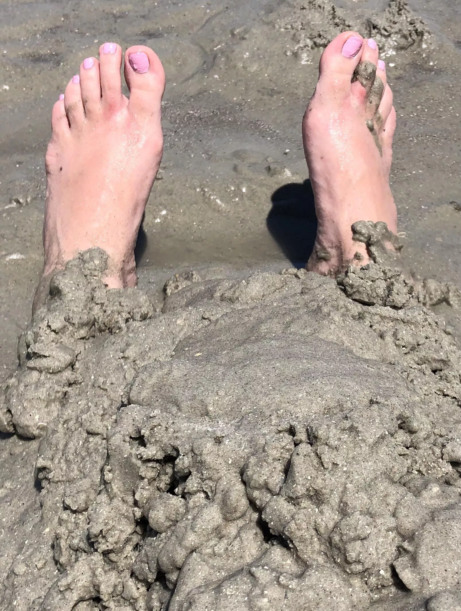 Only my vulnerable feet showing as I’m buried in wet sand at the beach!