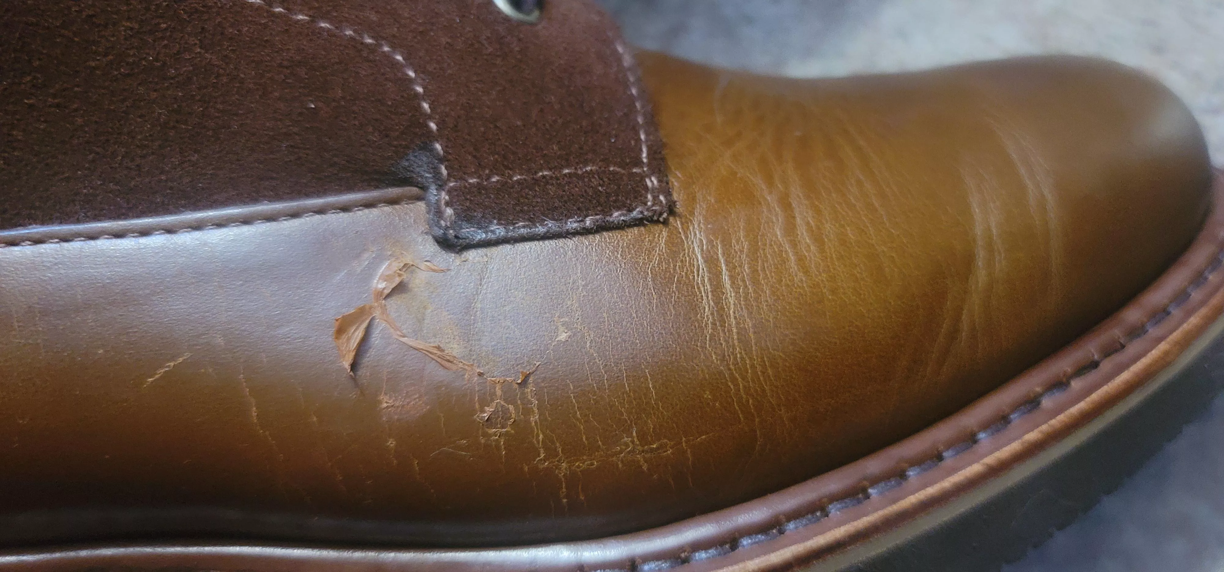 Peeling coating or something on leather of boot?