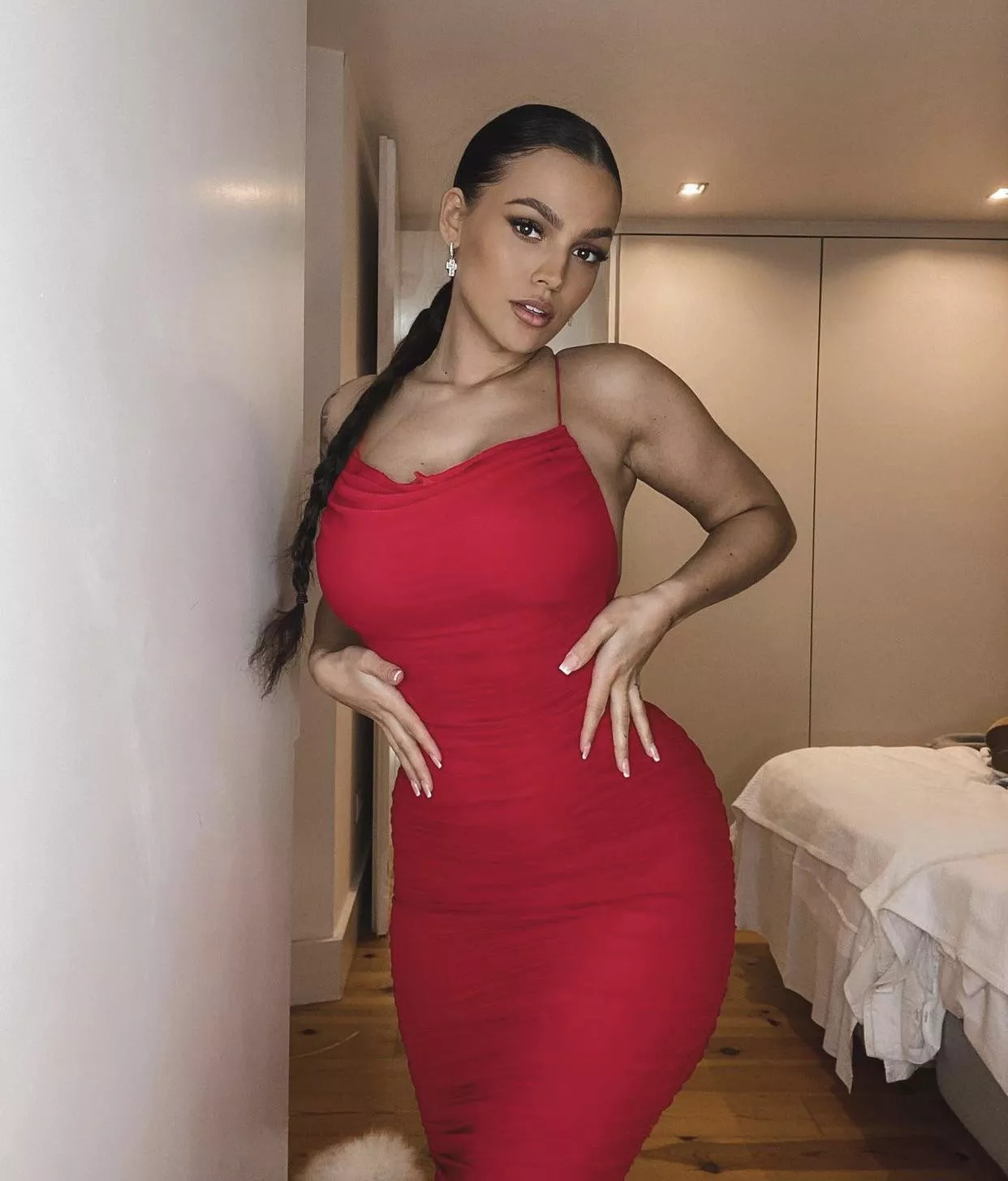 Red dress defines her curves