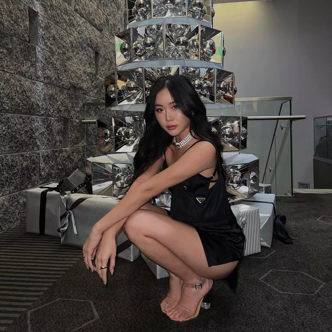 Squatting in black dress and heels