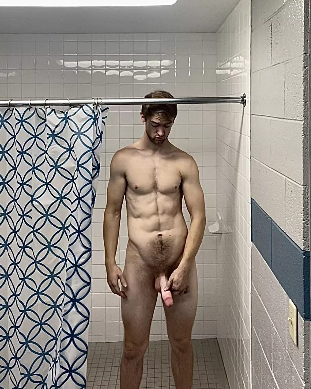 Tall drunk man inspects penis before shower