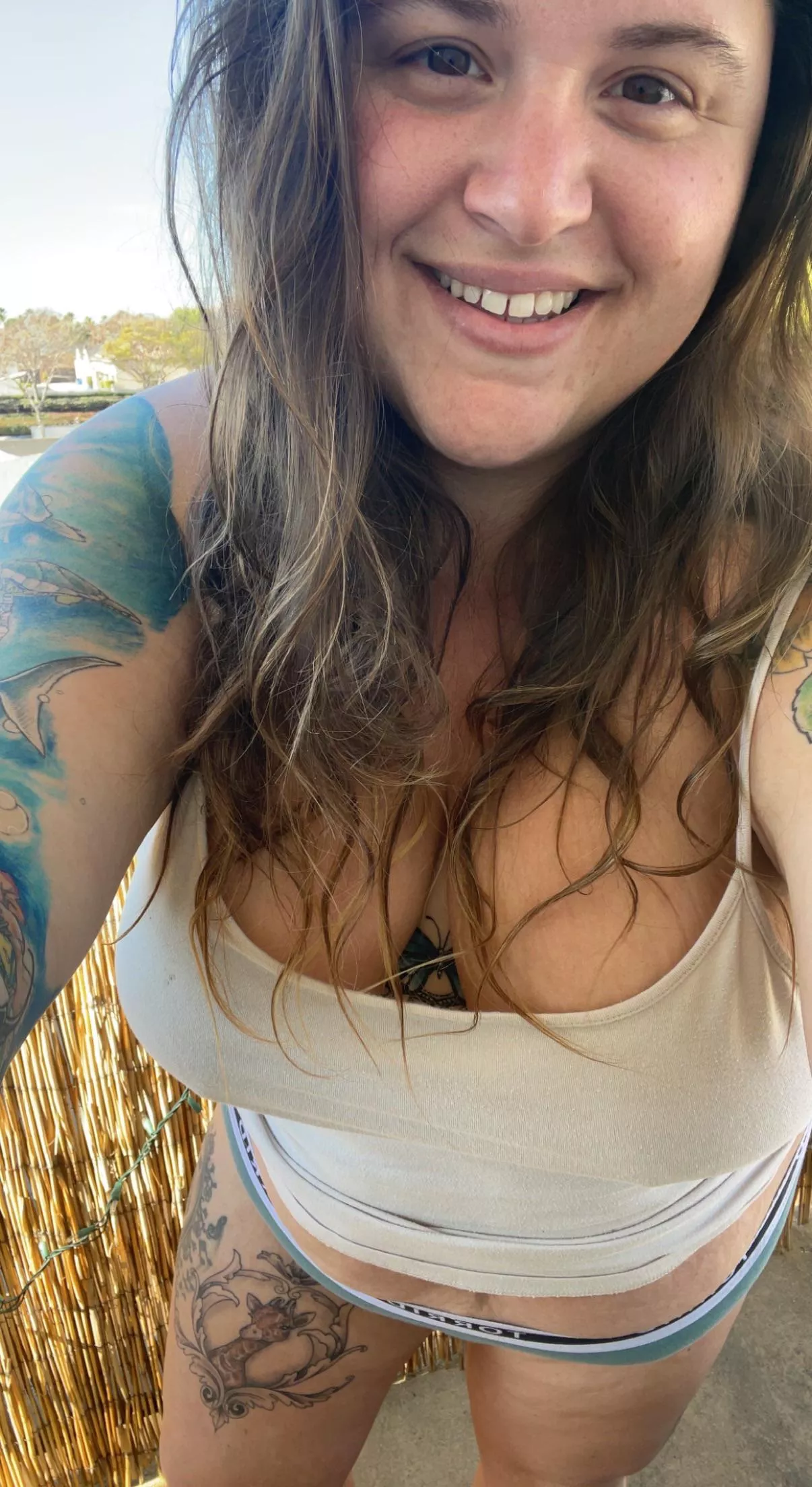 tattooed all natural stoner with big boobs and a seductive smile