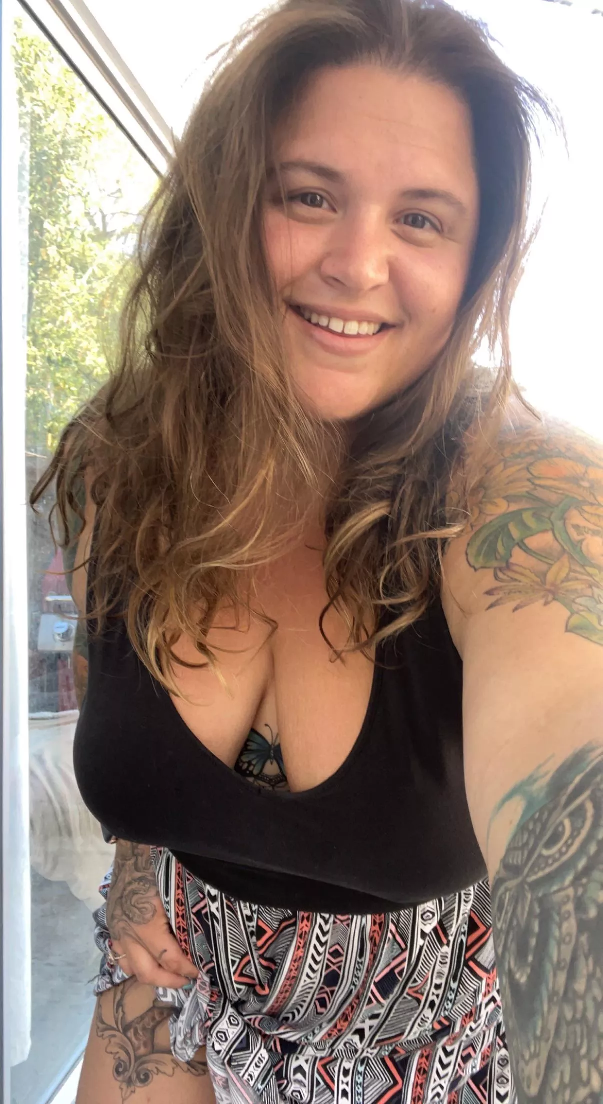 tattooed all natural stoner with big boobs and a seductive smile