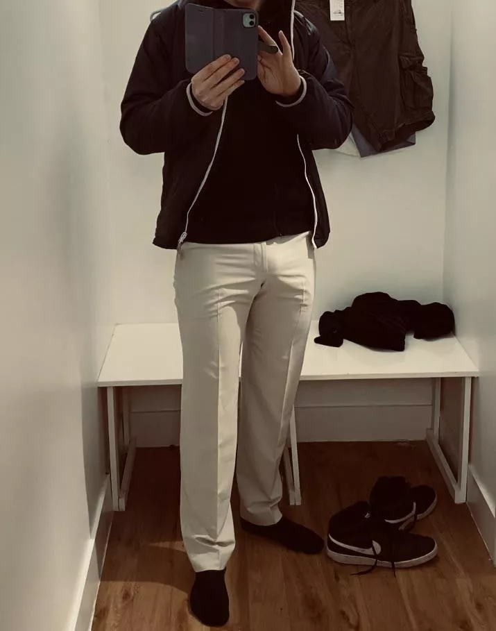 Trying on trousers in the changing rooms.