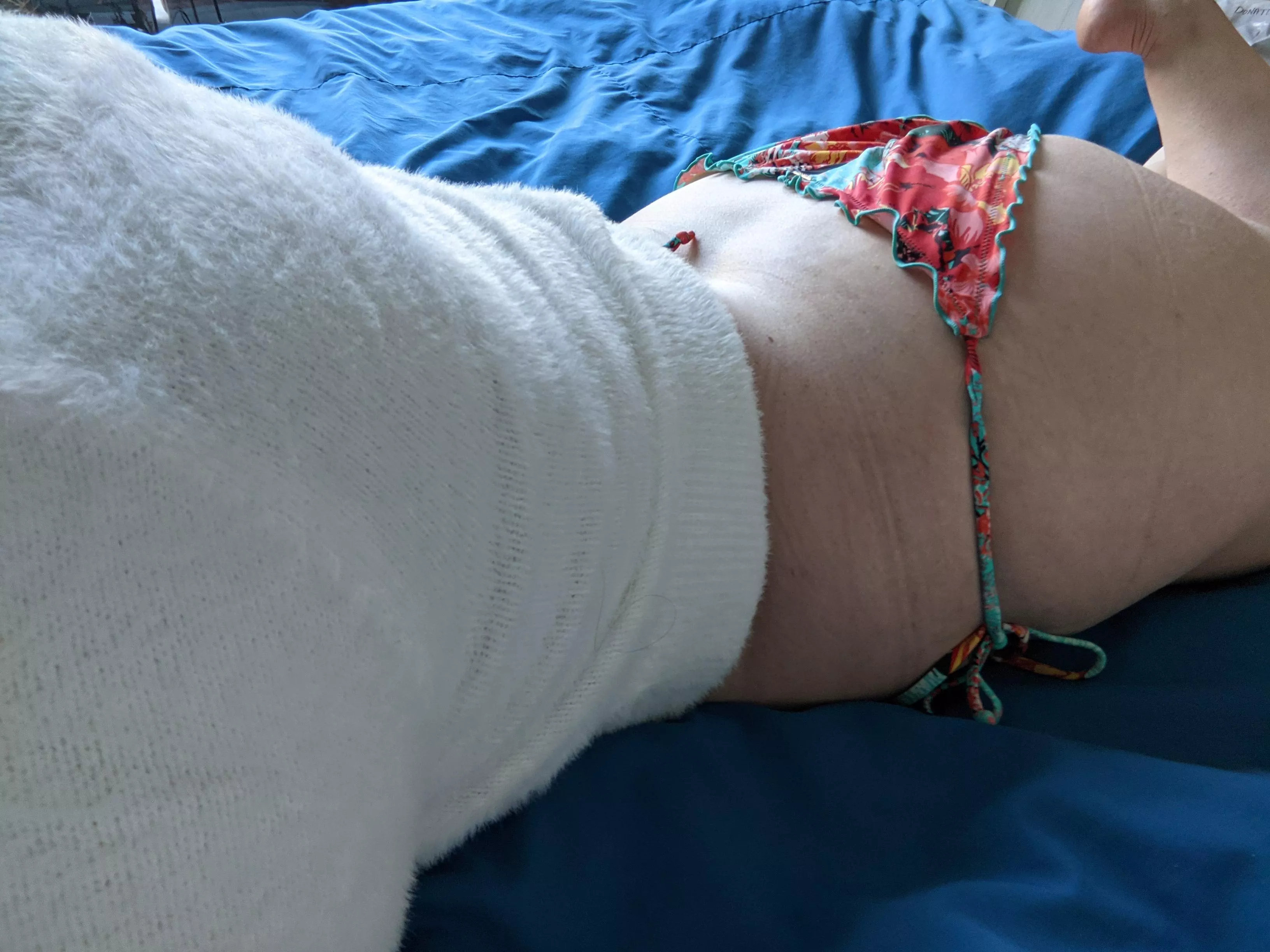 A tale of contradiction: a soft, fuzzy, white midriff sweater and colourful bikini bottoms! [F]