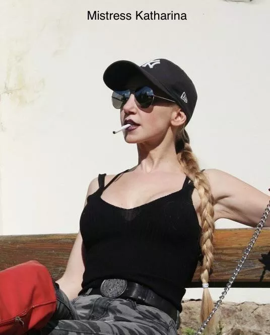 Beautiful Mistress smoking and relaxing in the sun.