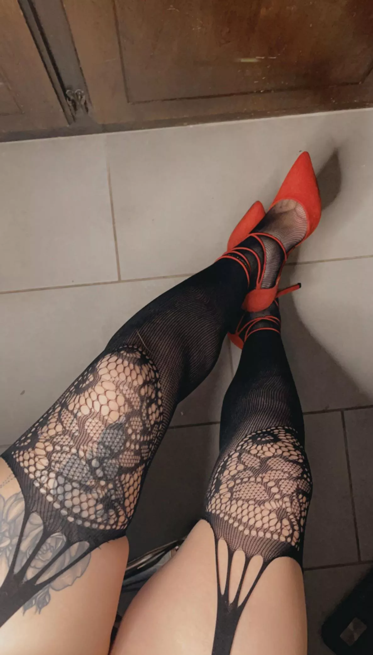 Can’t go wrong with fishnets and red heels