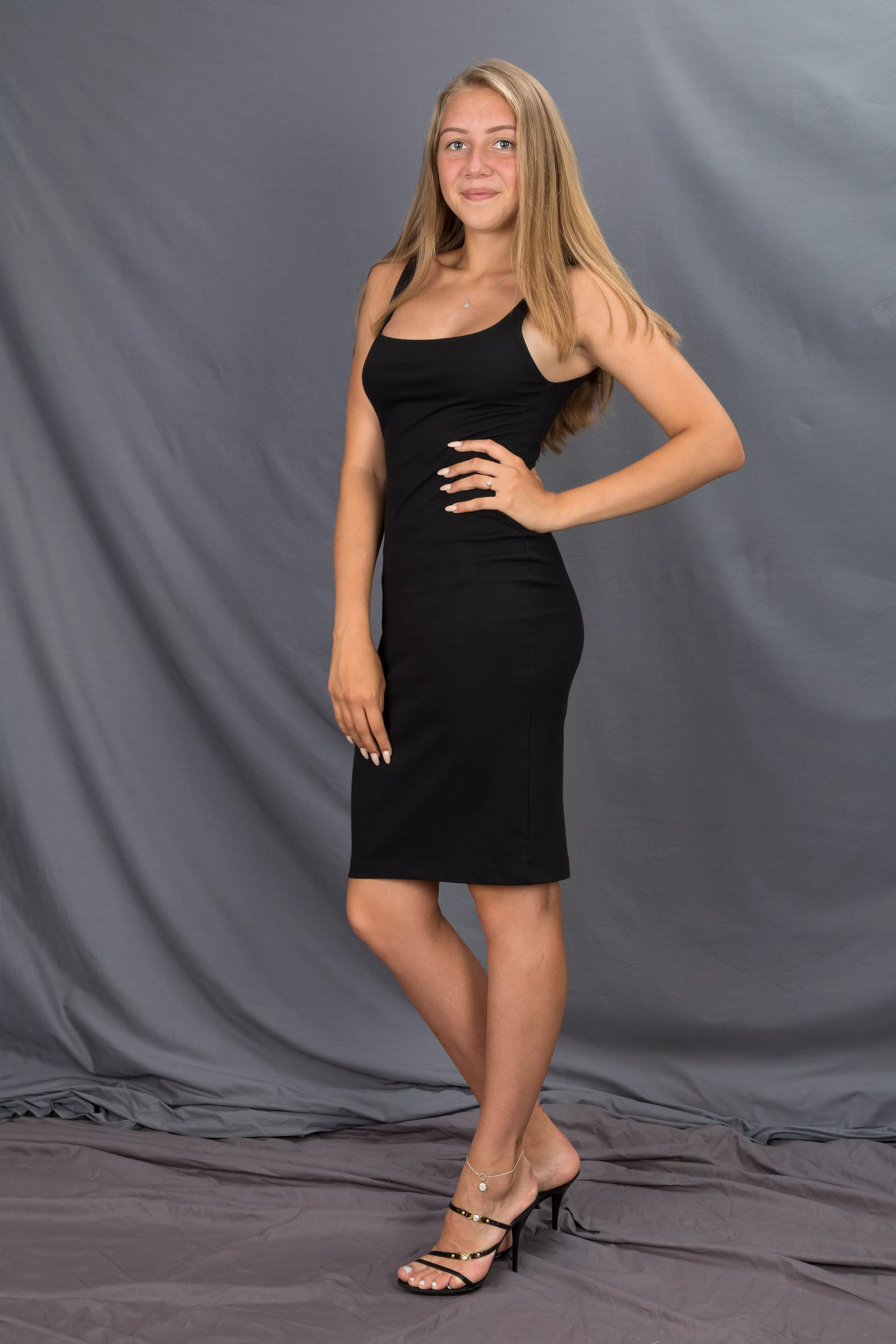 College girl in black dress and heels with anklet