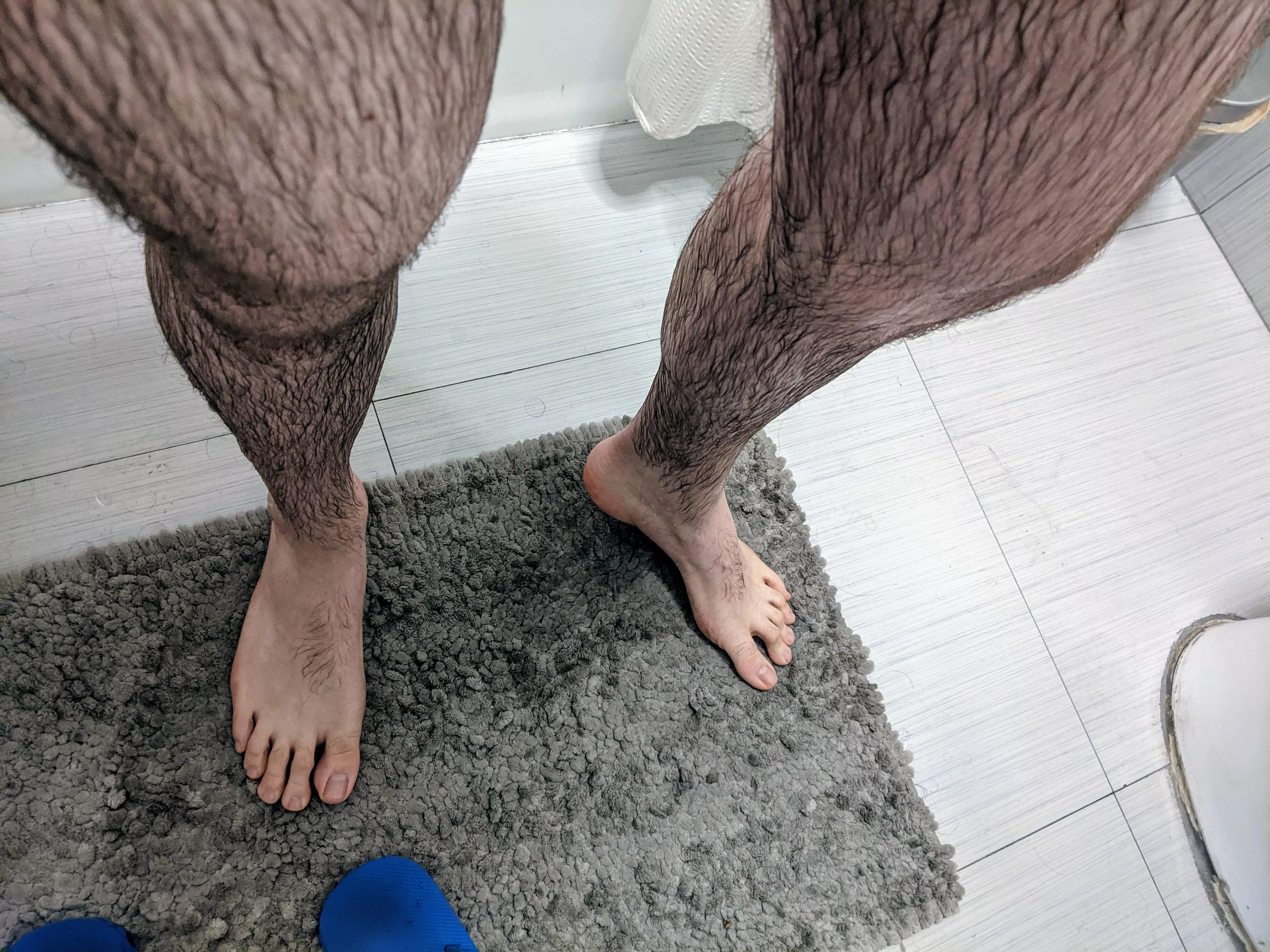 Freshly showered, legs and feet are still wet