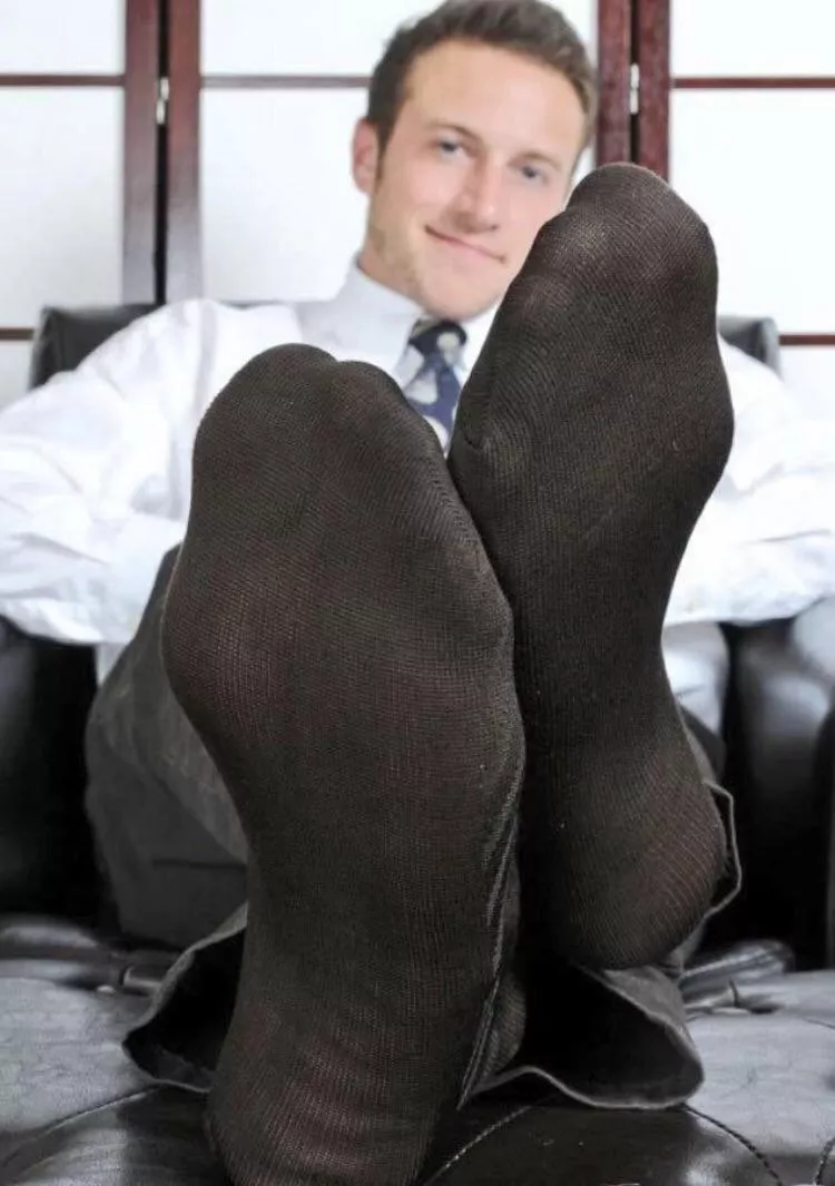 His toes are visible through his socks.