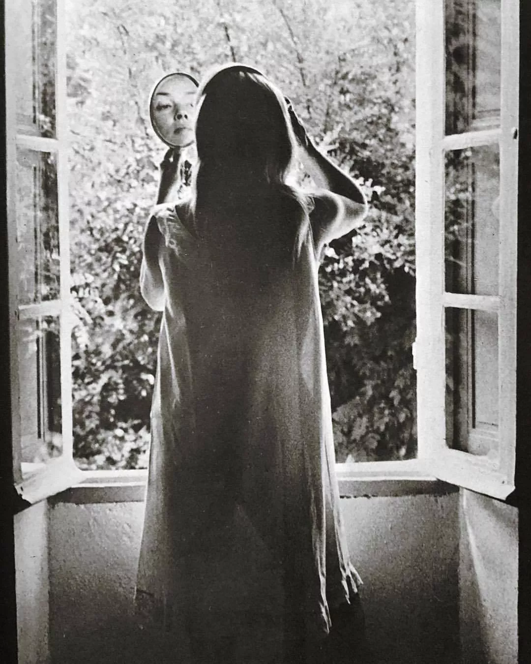 Jeanne Moreau at the window of her Côte d’Azur villa, 1967. Photographed by Cyril Morange, TLPA