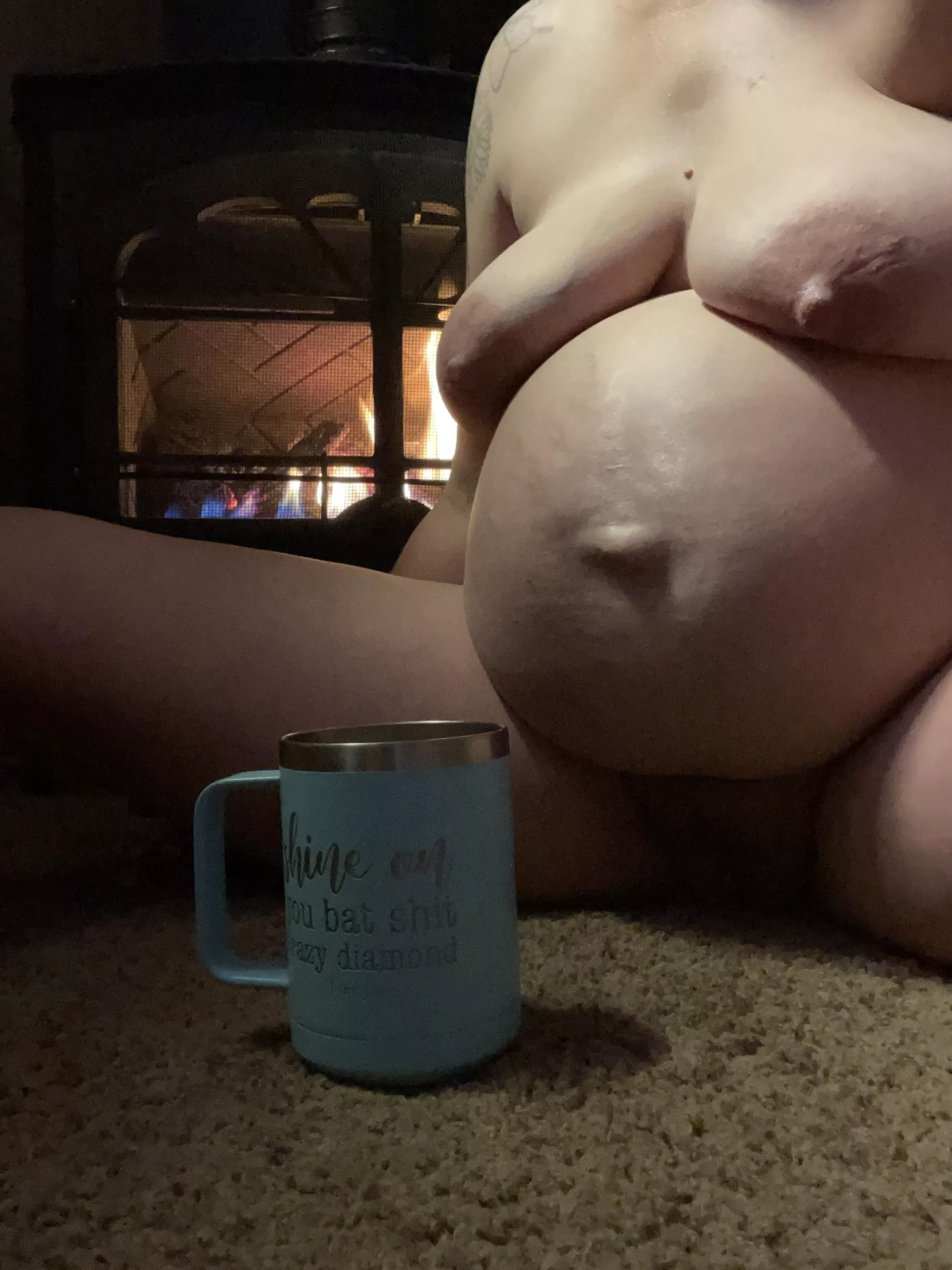 Late night coffee sitting by the fire naked.