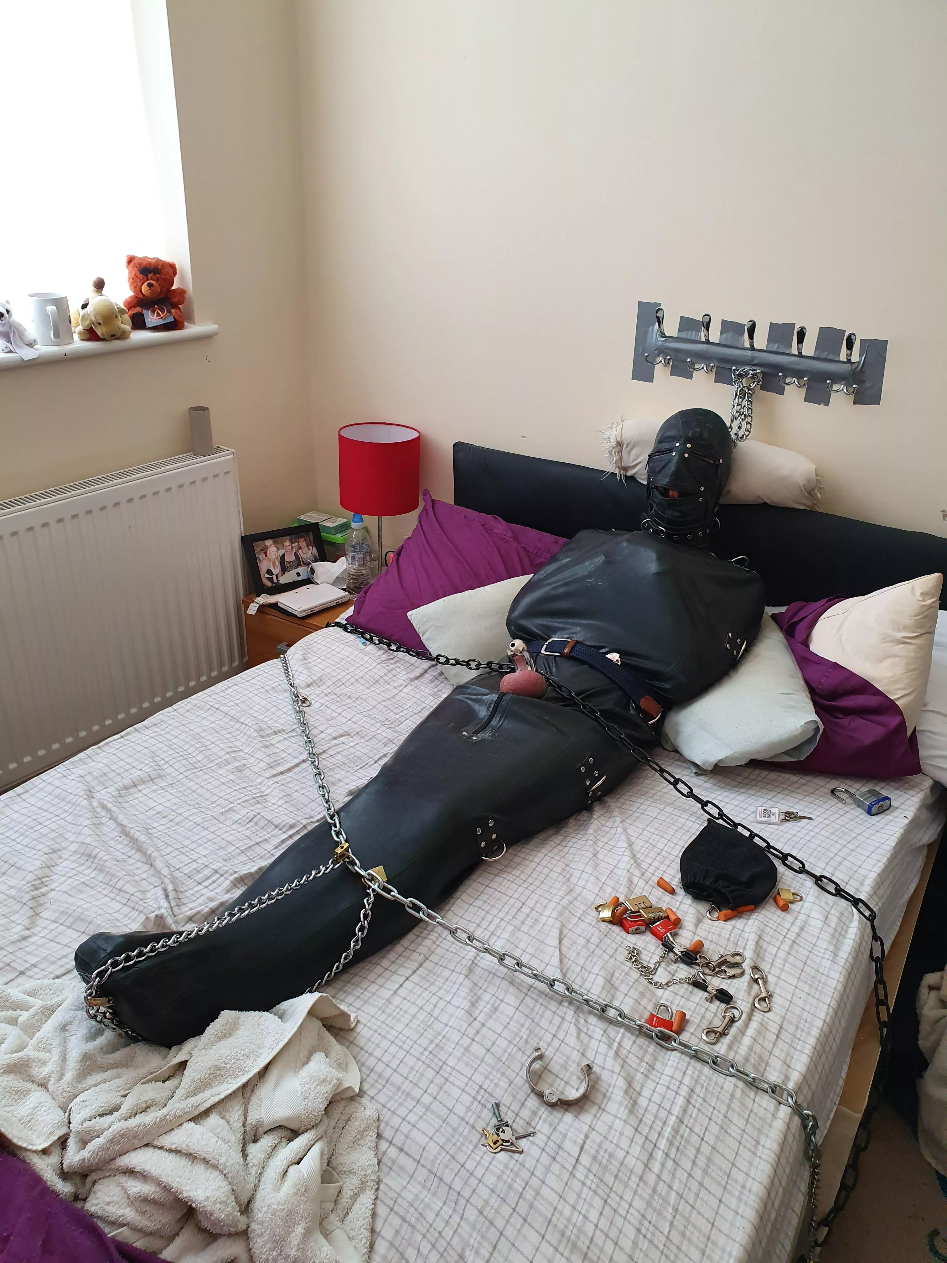 Me all sleepsacked in rubber suit, chained & padlocked & handcuffed & collared & gagged in chastity for god knows how long while my partner was at work with the keys ;)