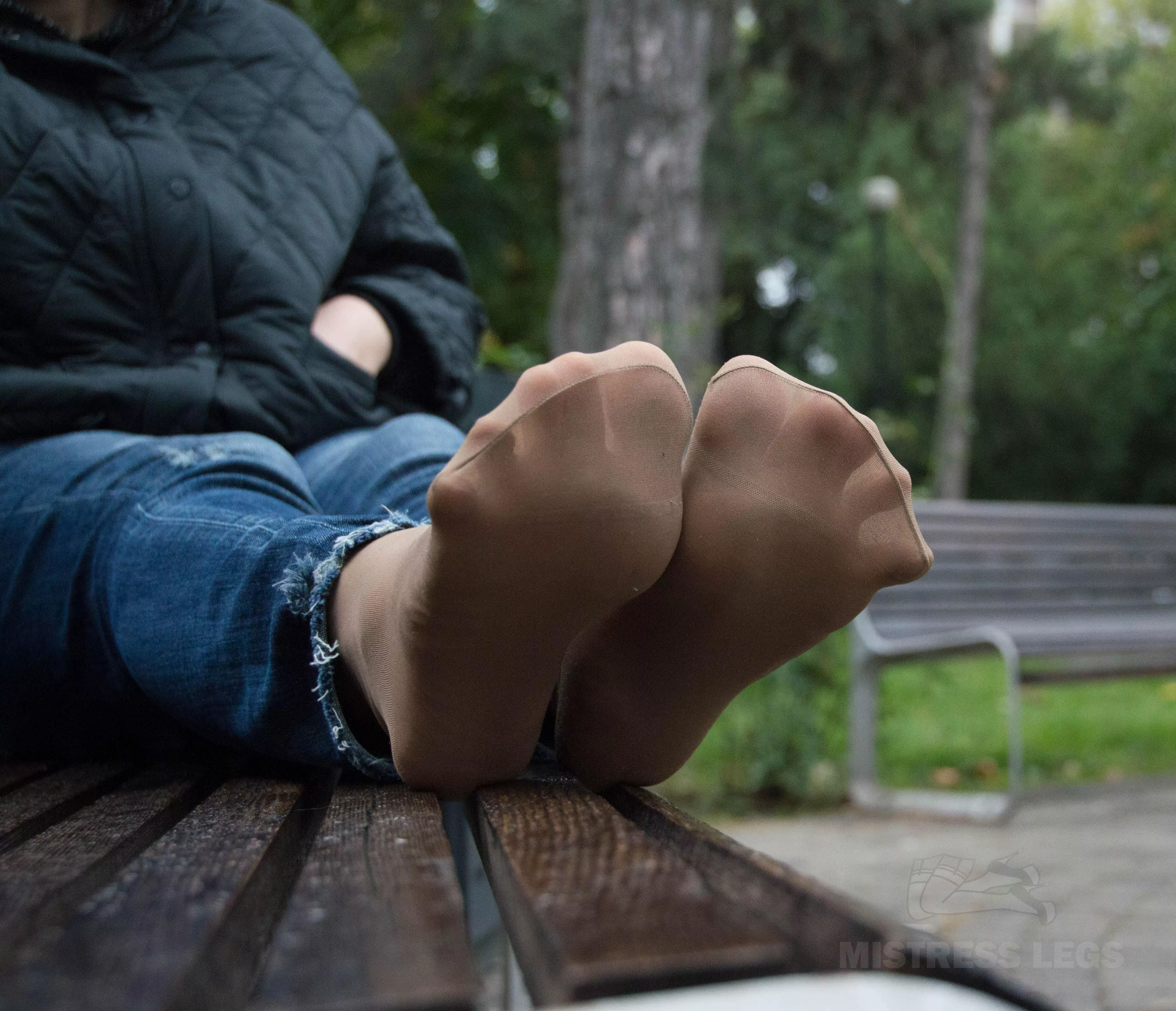 My cute sweaty nylon soles outdoor on the bench at a rainy day