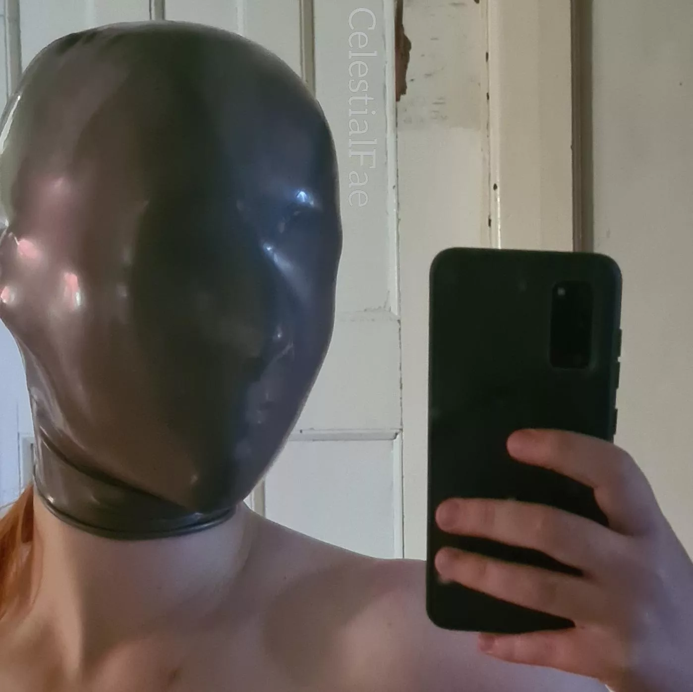 Mysterious redhead in micro-perforated latex hood 🤣