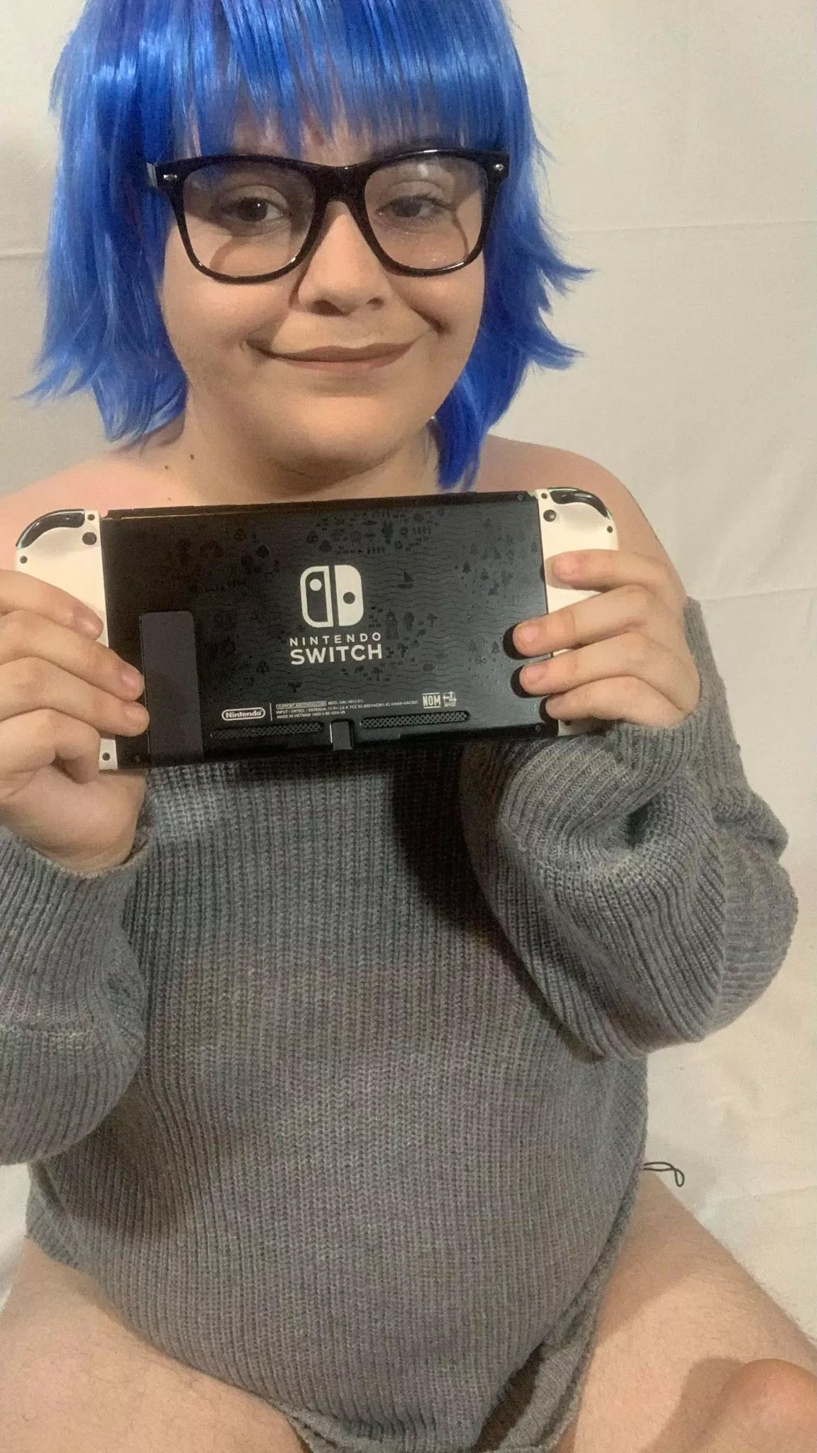 Nikki faking a smile when gifted a newer gaming console