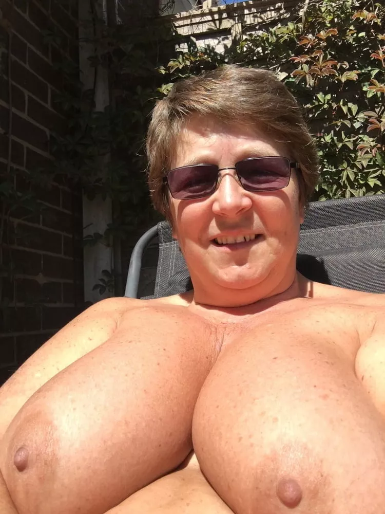 Nudist tanning her huge tits