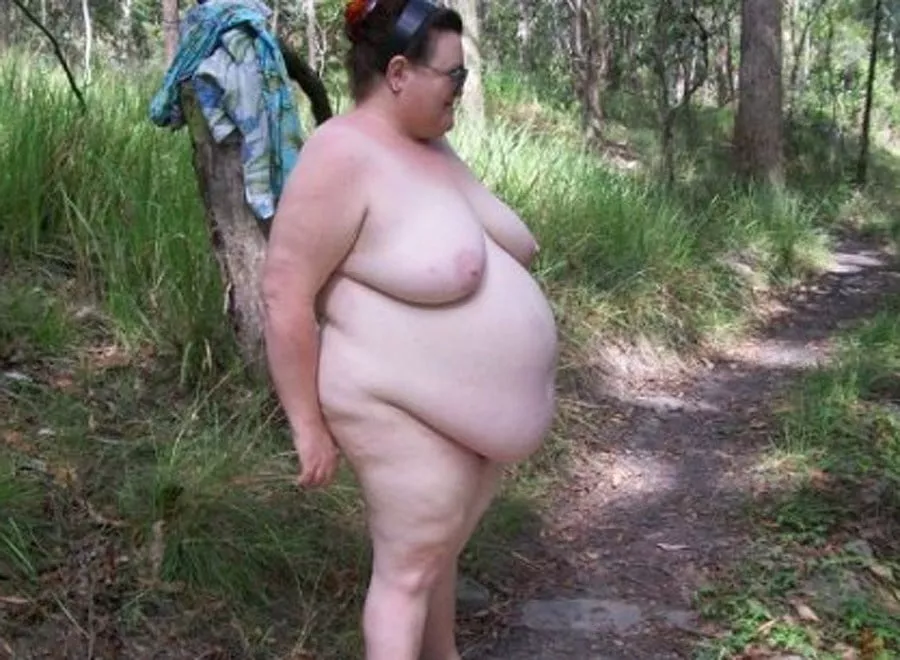 Nudist with a big belly on the nature trail