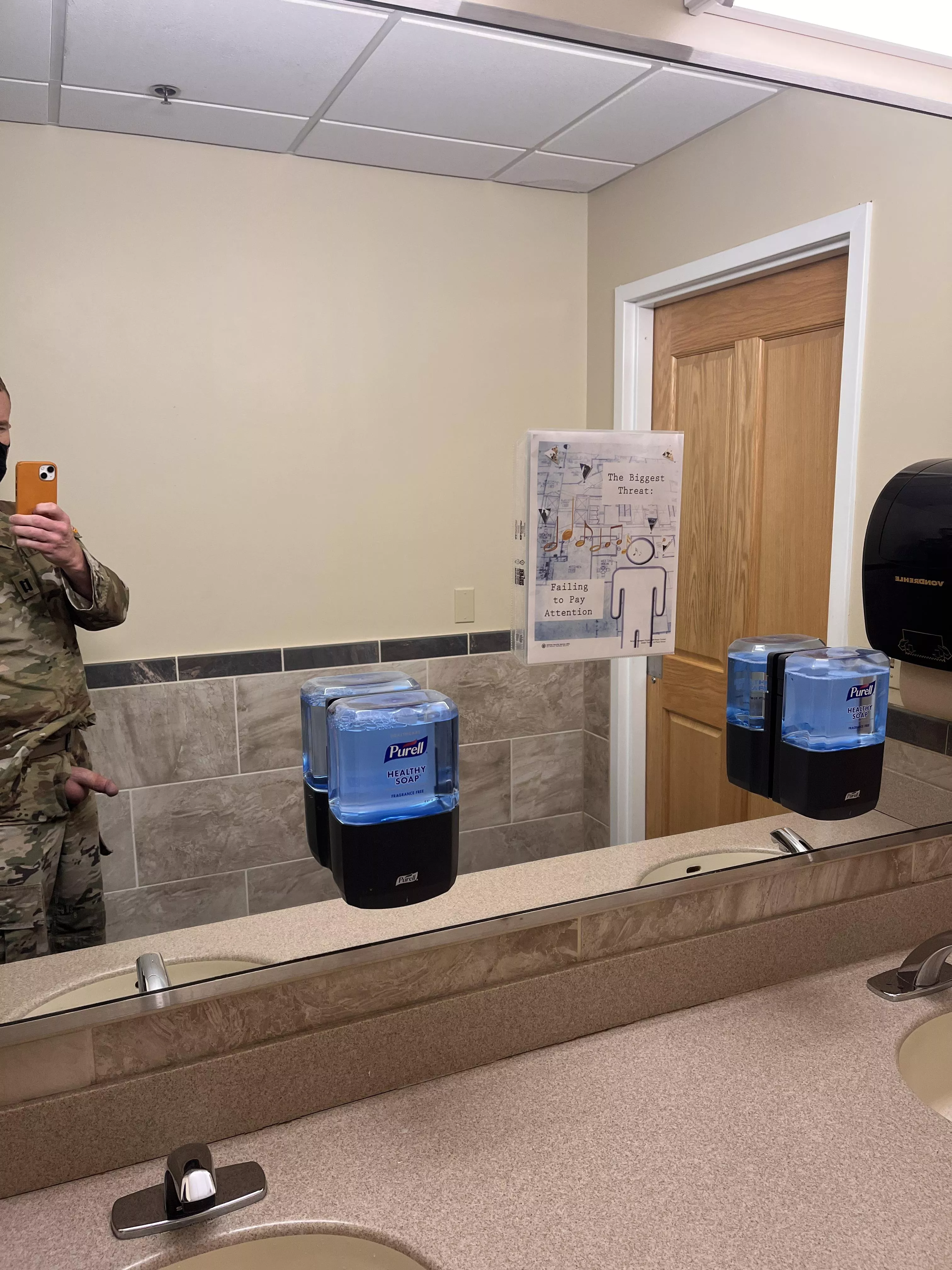 Public restroom. One guy in stall, two talking right outside the door