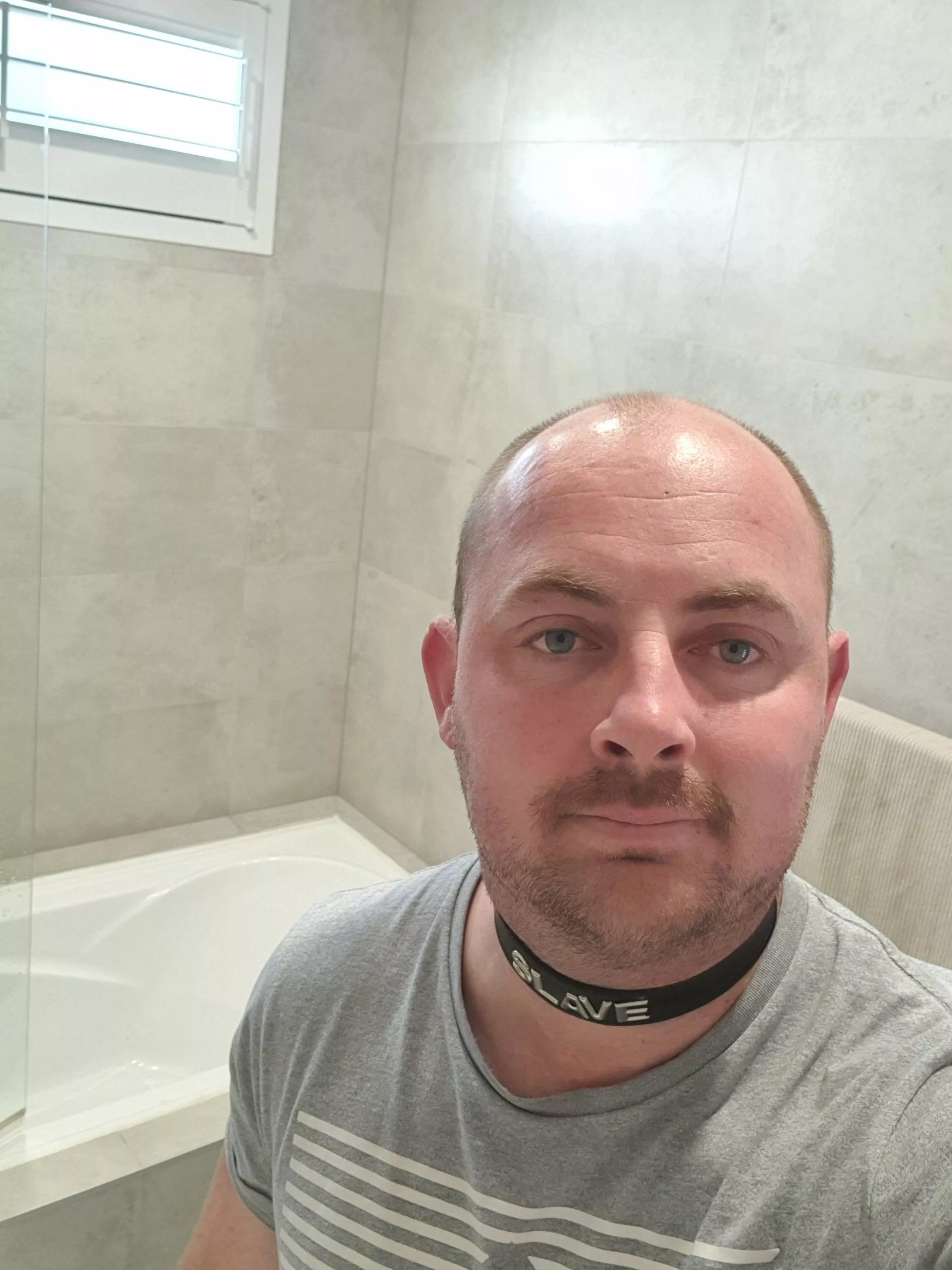 Slave collar while cleaning bathroom