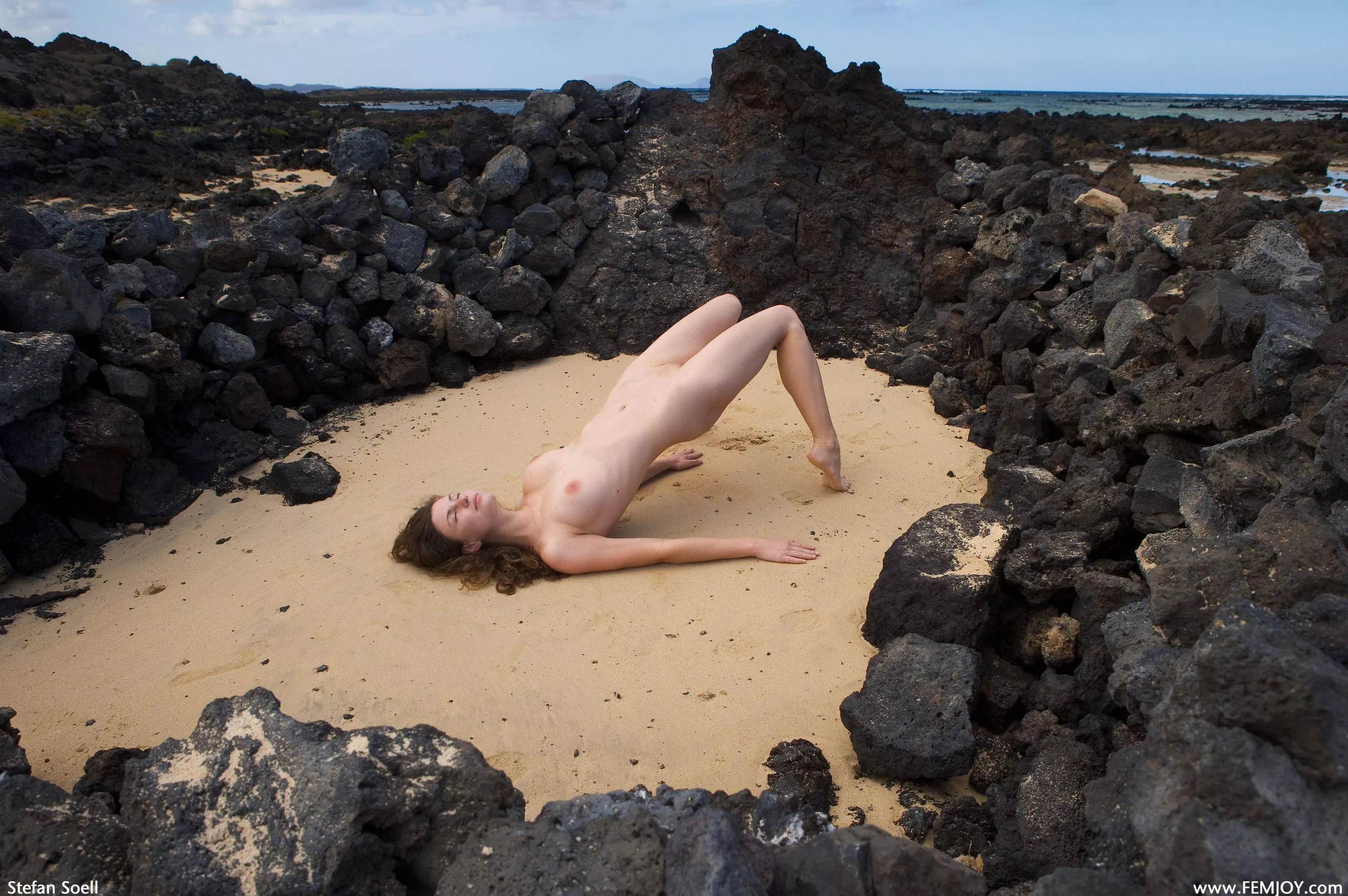 Susann among black rocks